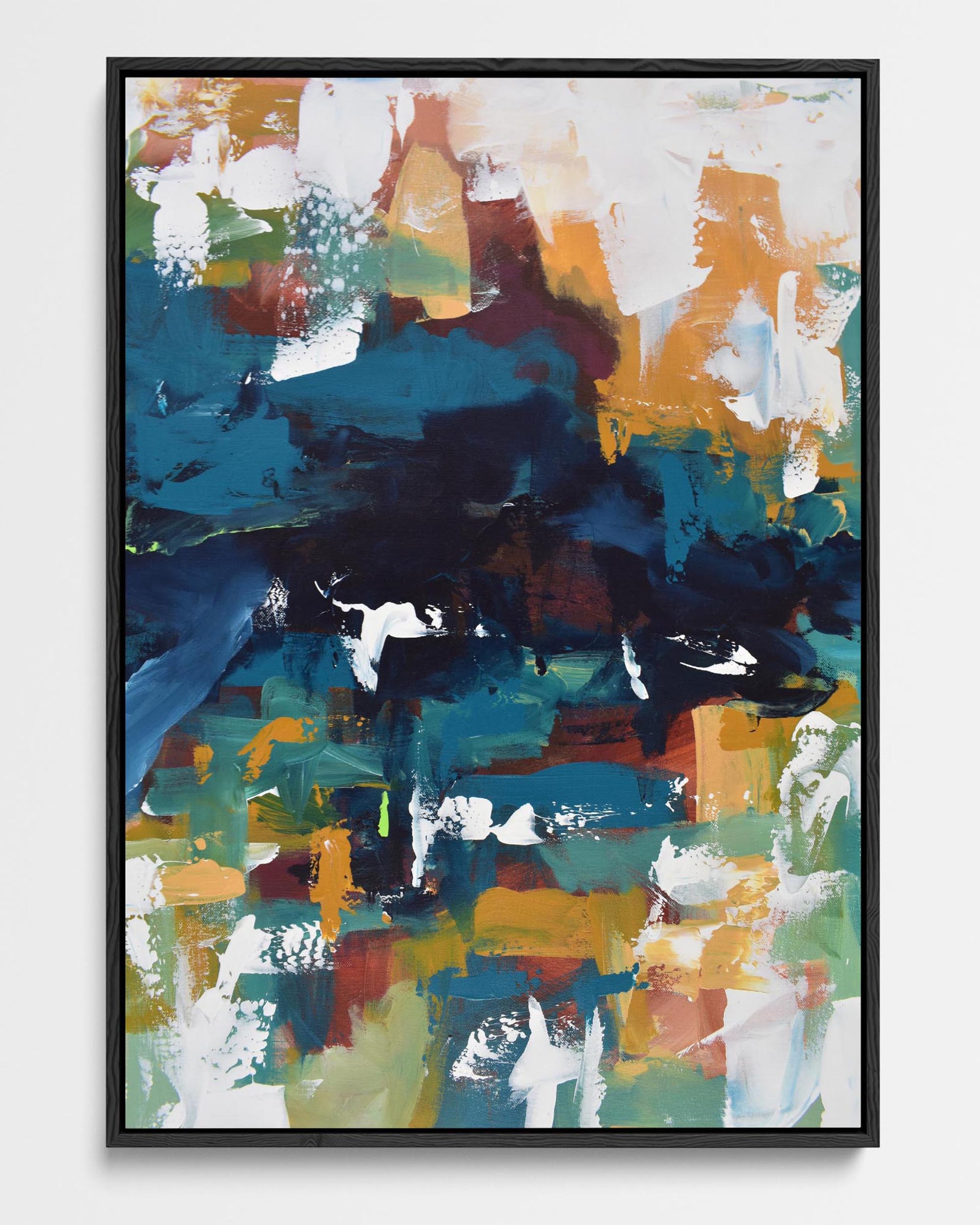 A framed canvas featuring an abstract painting with a mix of teal, navy, and amber colors, with white spaces creating a contrast.