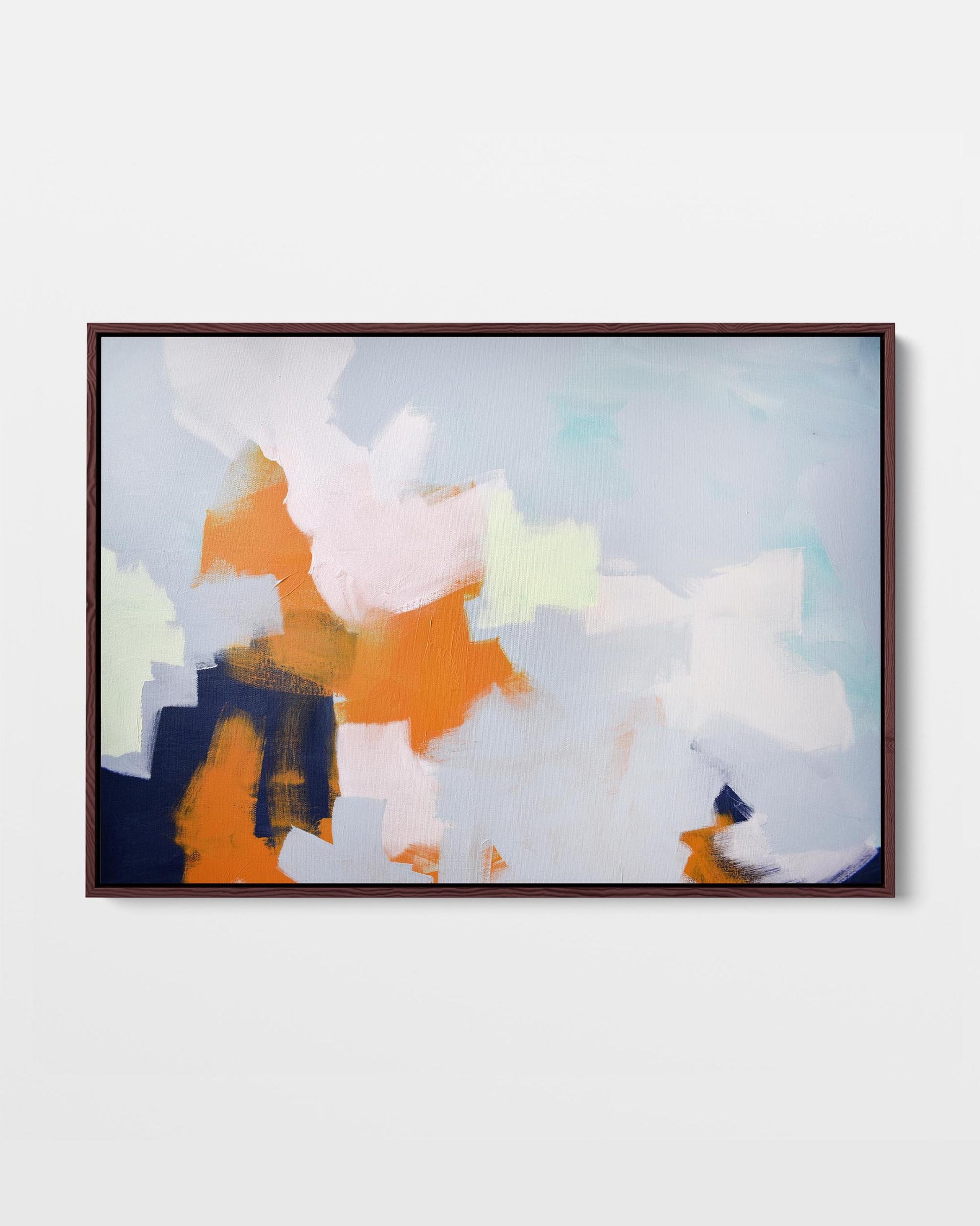 A framed canvas with an abstract cloud design featuring modern blue, pink, orange, and navy tones.