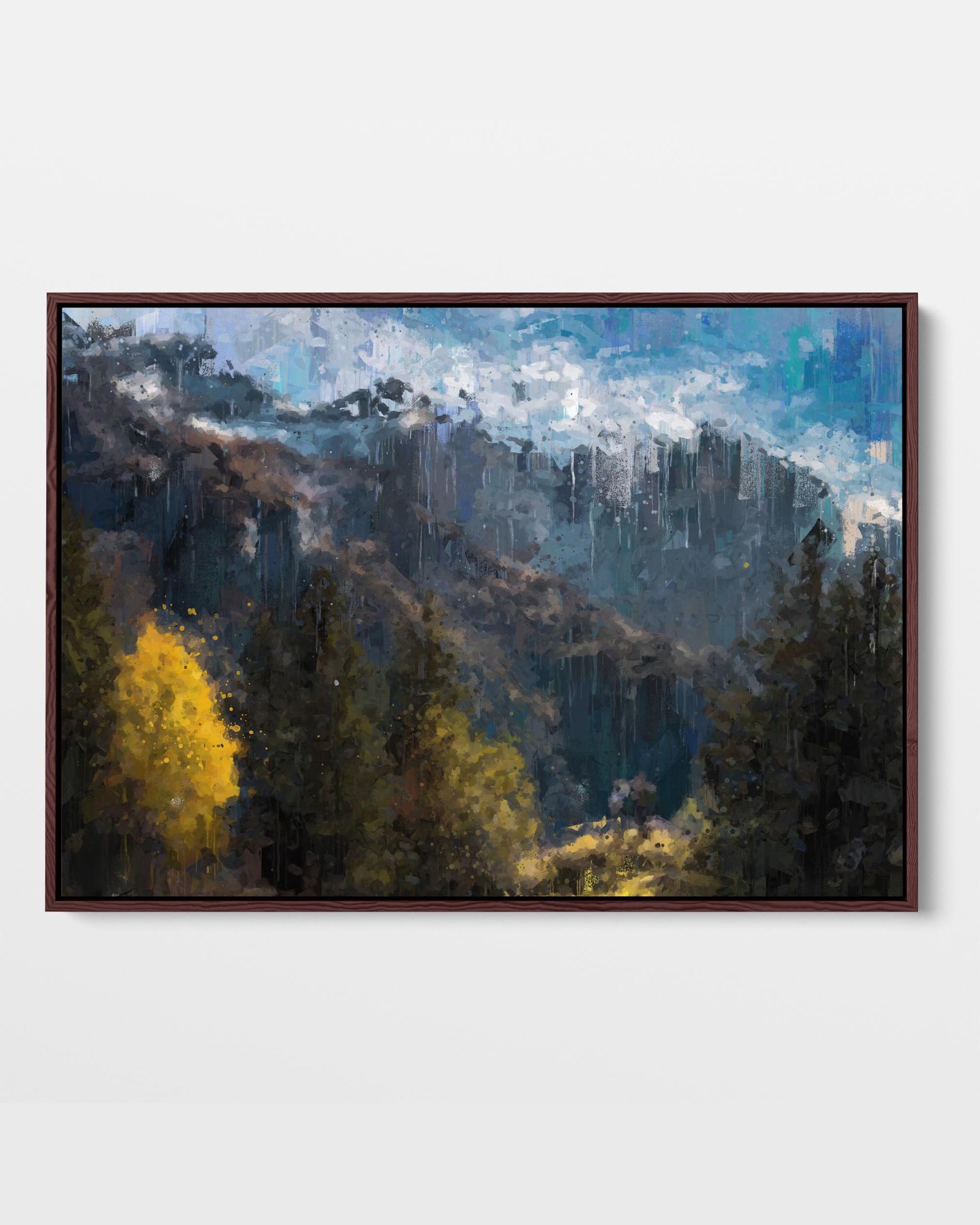 Framed canvas print depicting a mountain valley with trees in autumn colors, under a blue sky with clouds.