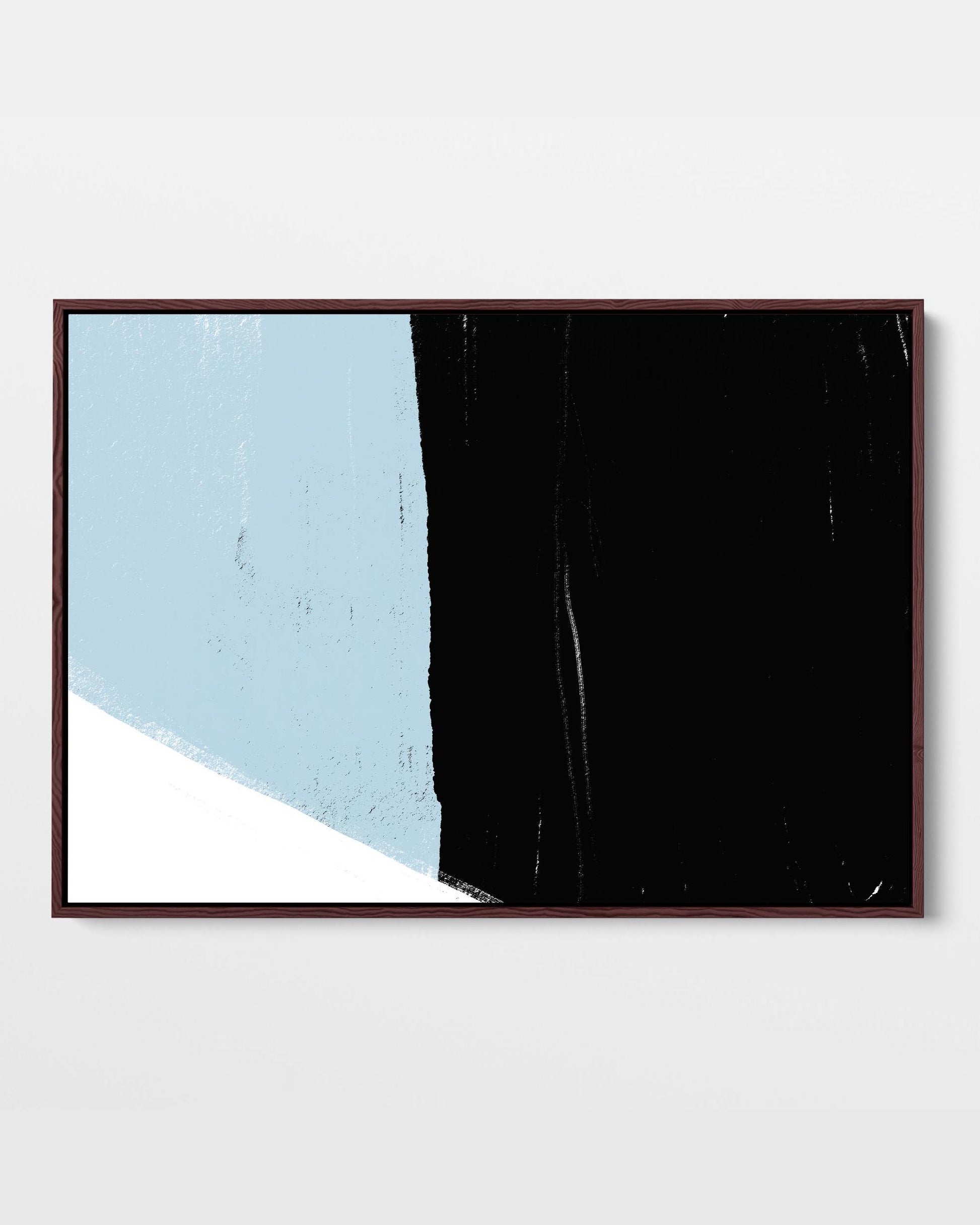 A framed canvas with abstract color blocks in black, blue, and white.