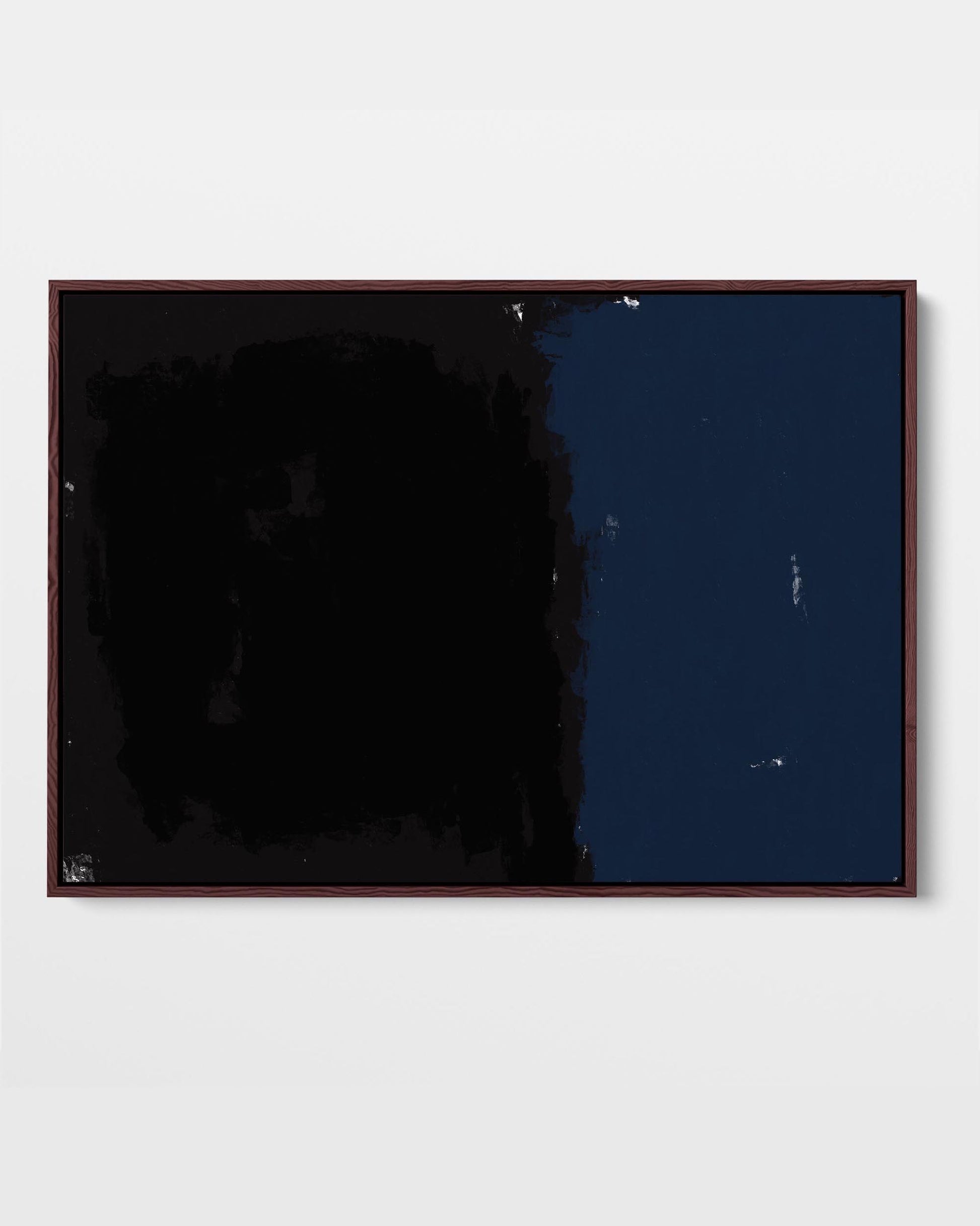 A framed canvas with abstract art, featuring shades of black and blue, presented in a simple wooden frame.