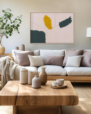 Modern living room with a beige sofa, wooden coffee table, and abstract art on the wall.