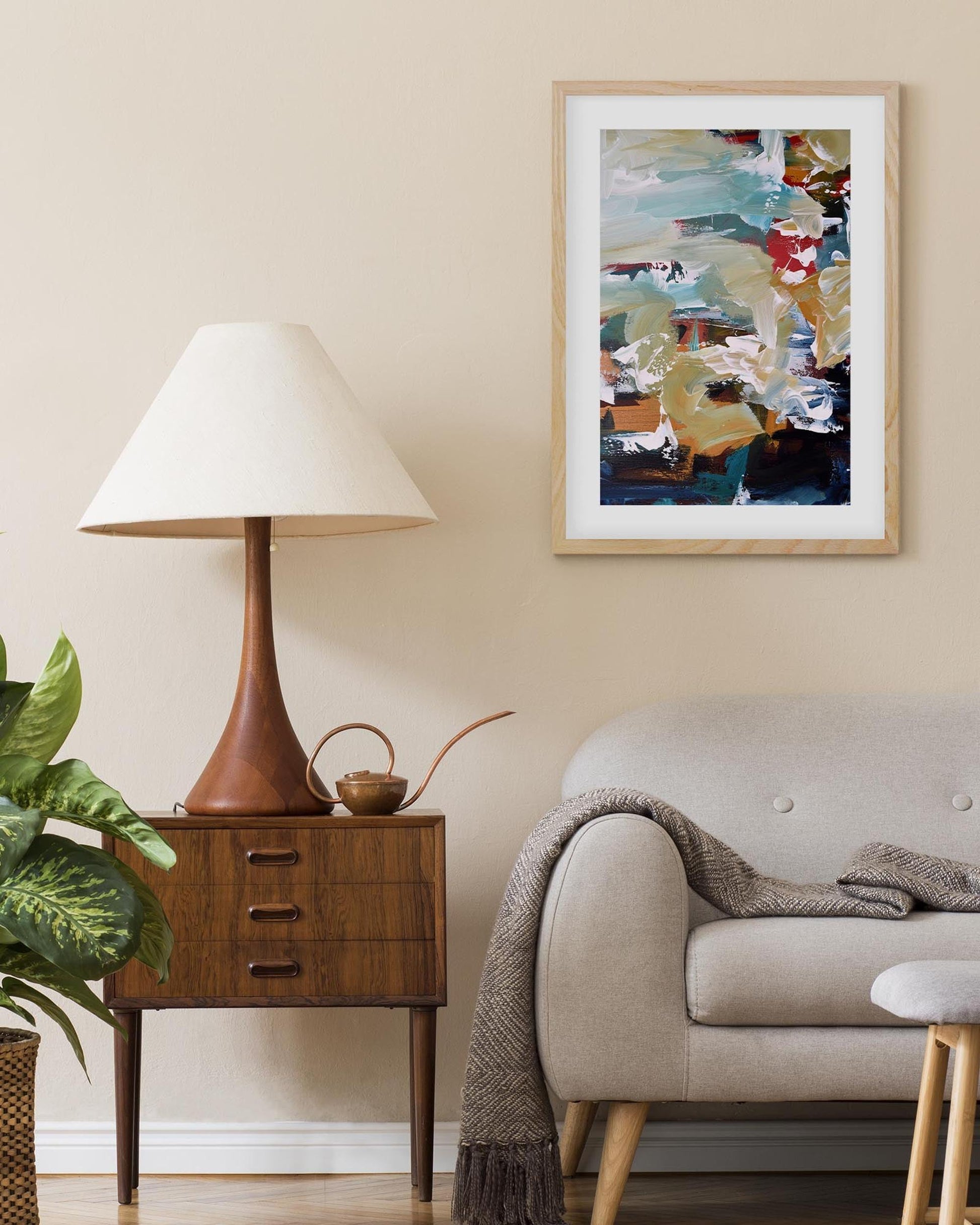 Living room with a lamp, sofa, and abstract painting on the wall.