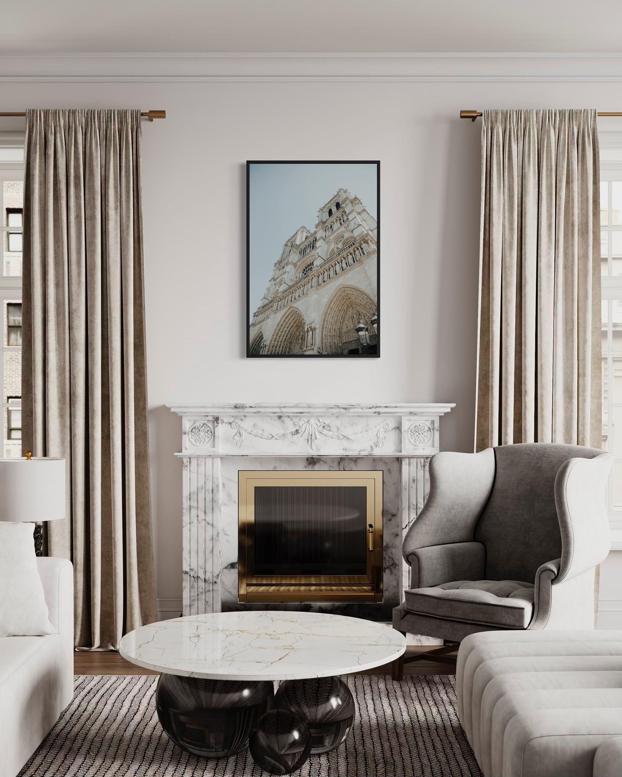 Modern living room with marble fireplace, gray armchair, and white sofa.