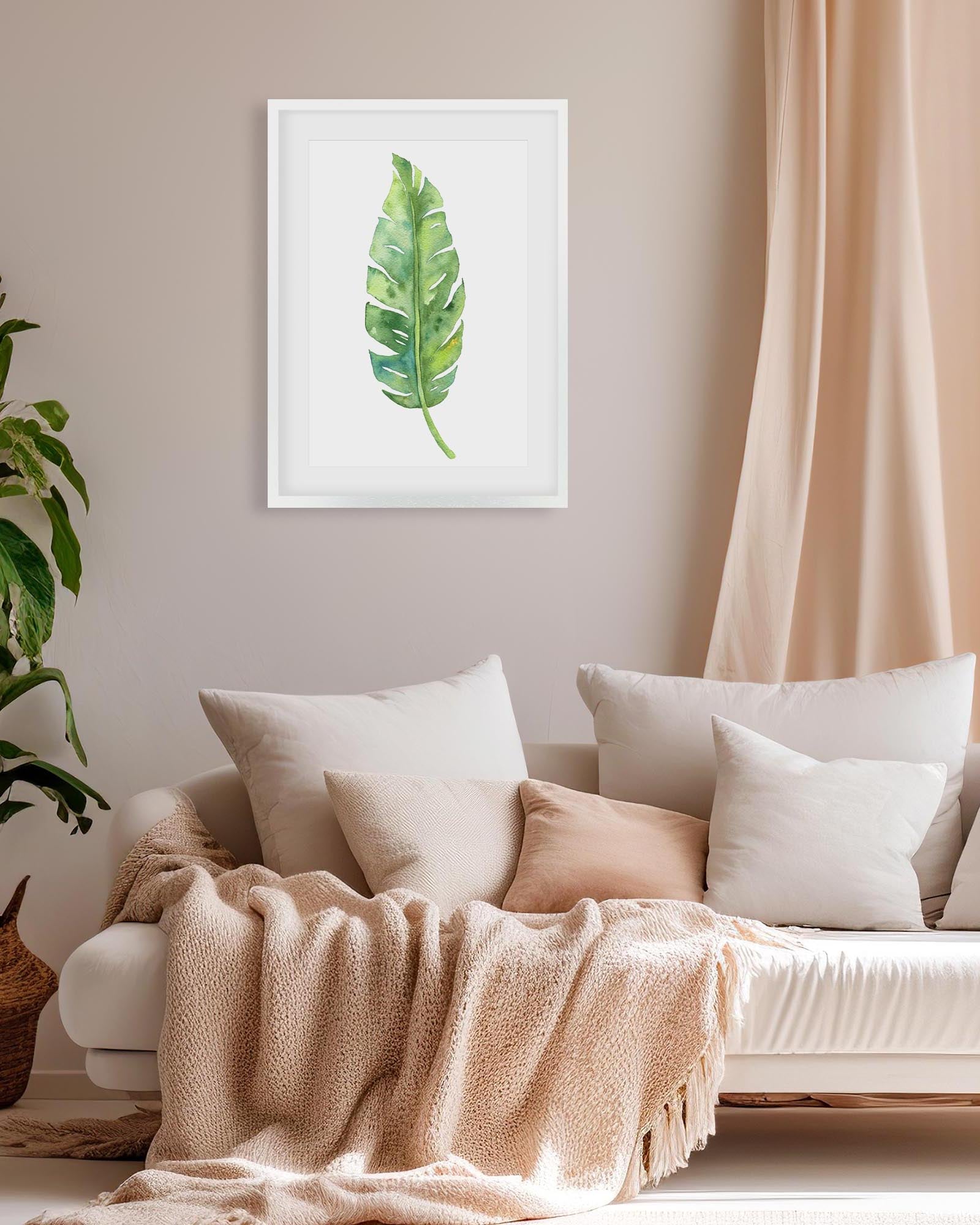 framed botanical art print above a beige sofa in a modern living room