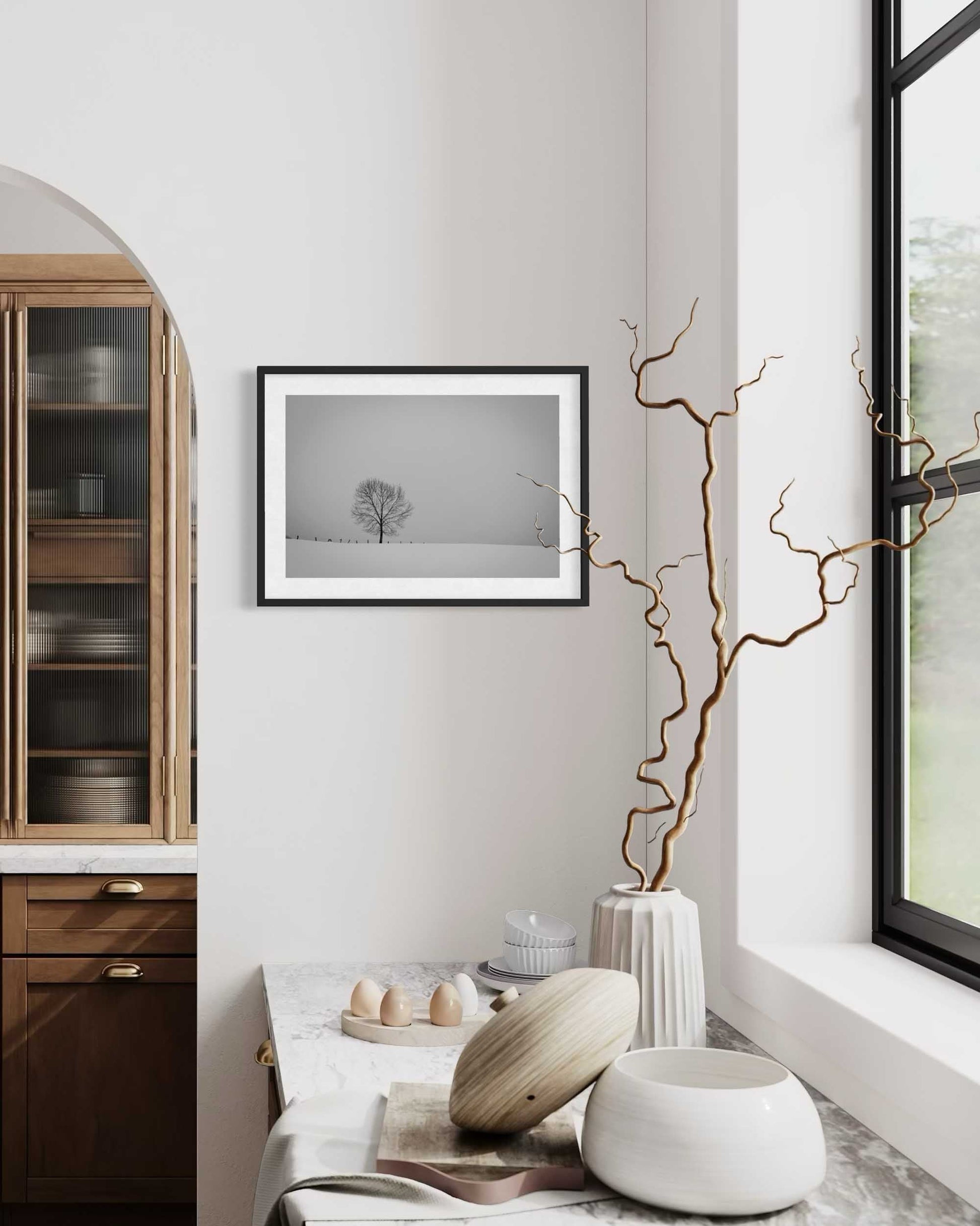 Modern interior with wooden cabinet, framed artwork, and decorative items.