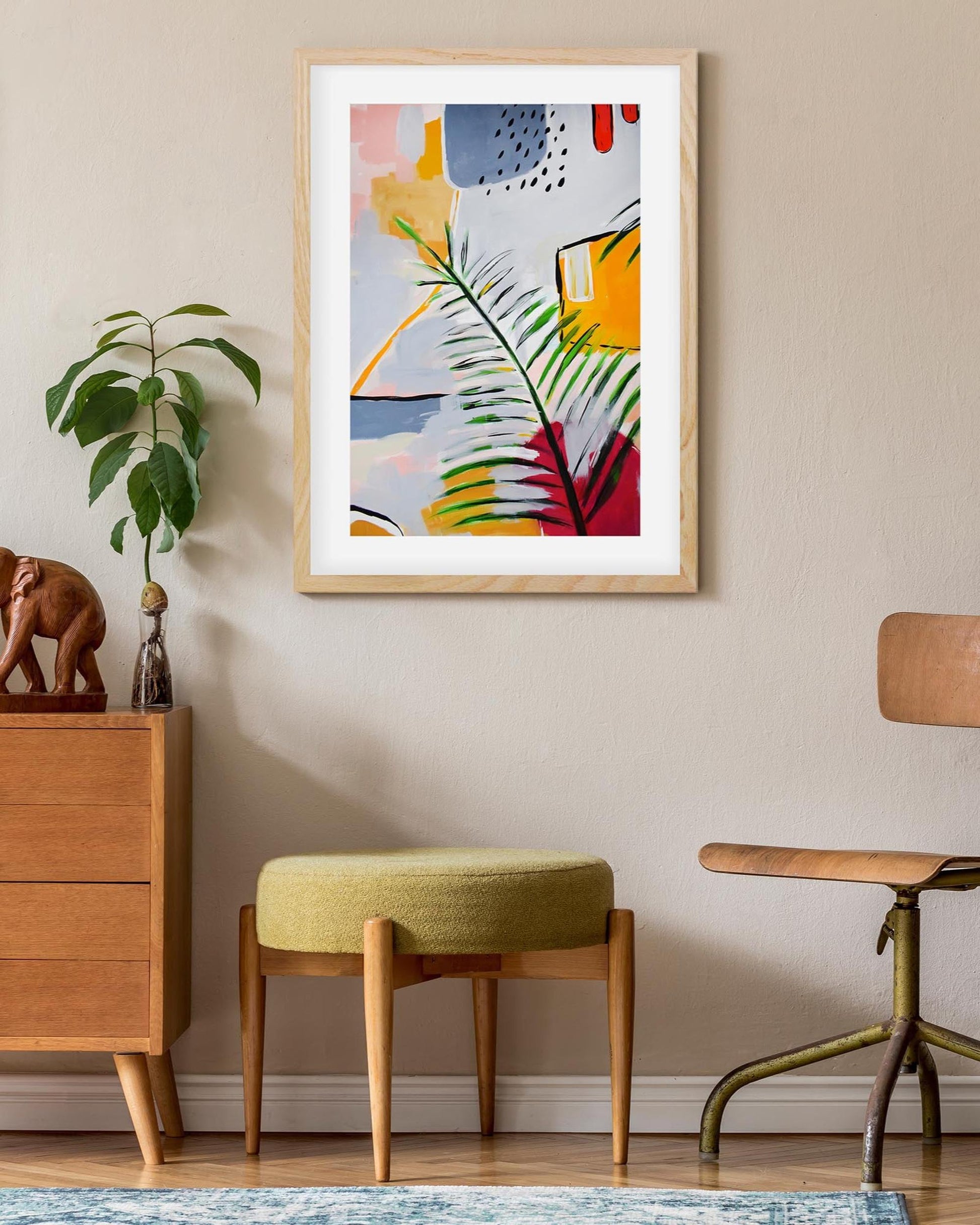 Colorful abstract art print on a wall in a room with furniture and decor.