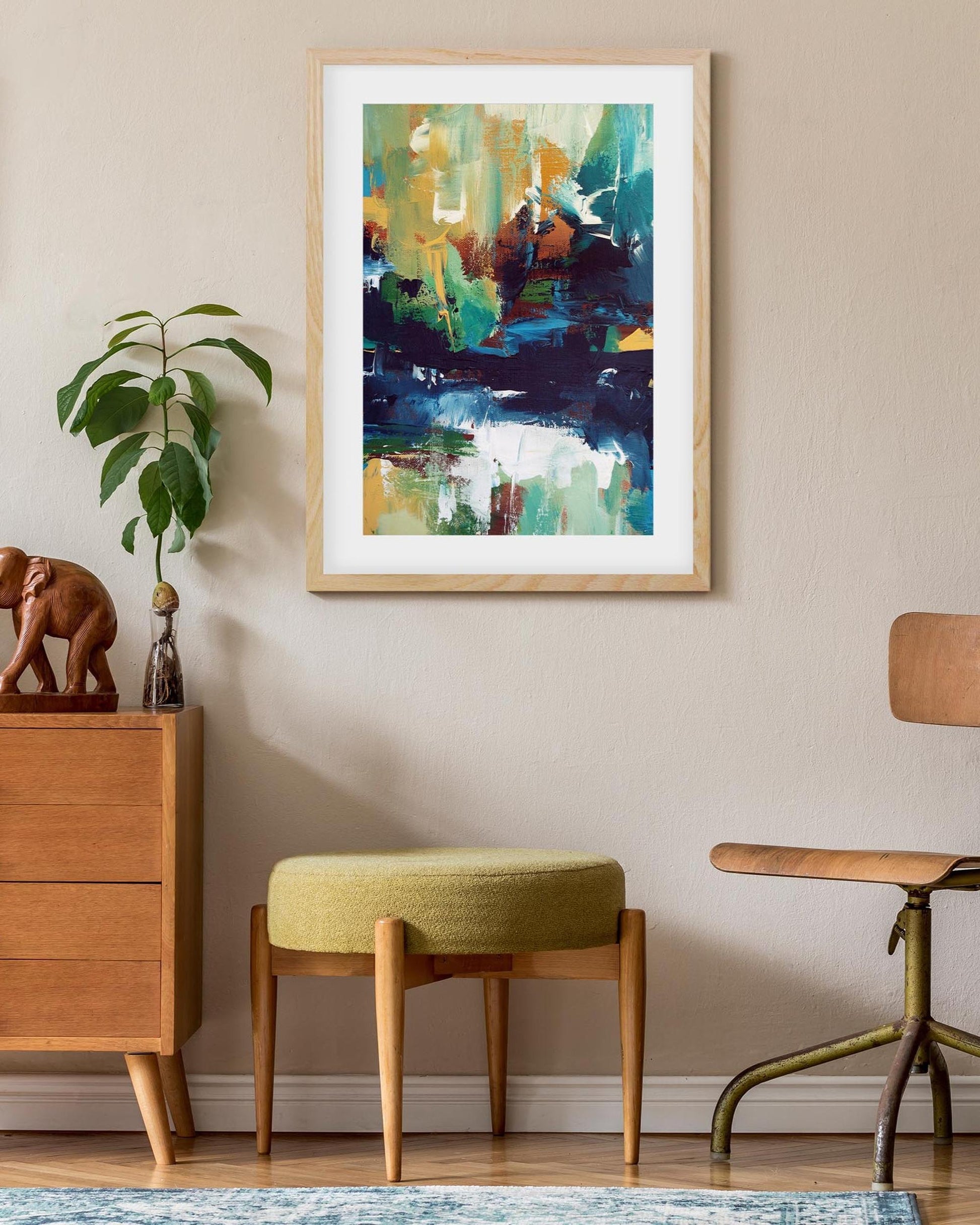Framed abstract painting on a wall with wooden furniture and decor items.