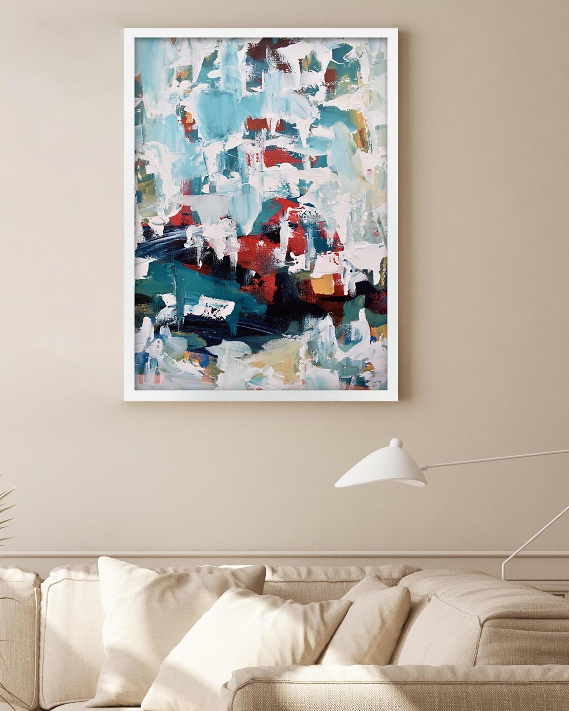 Abstract art print on a wall above a sofa