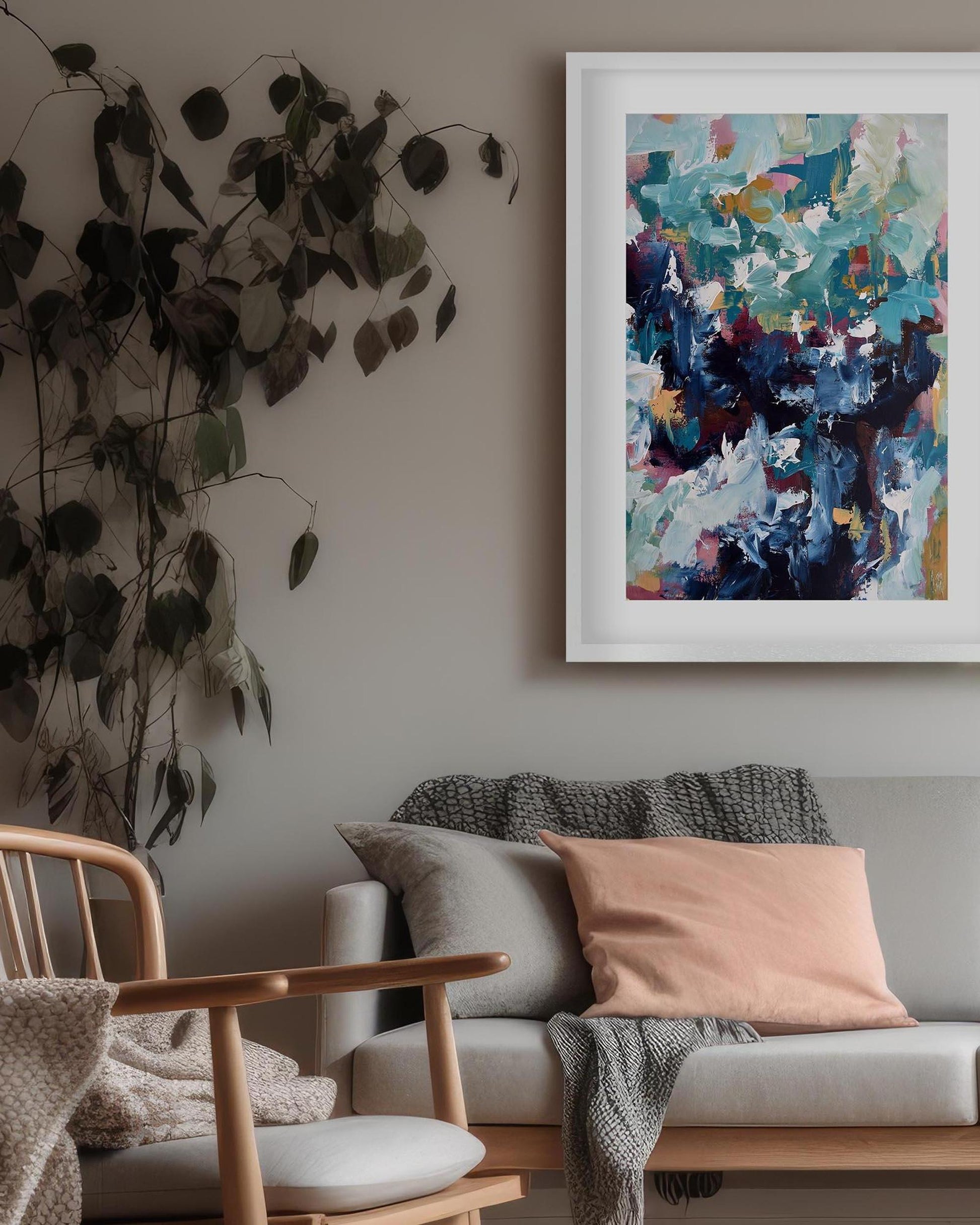 Living room with a gray sofa, wooden armchair, and abstract art on the wall.