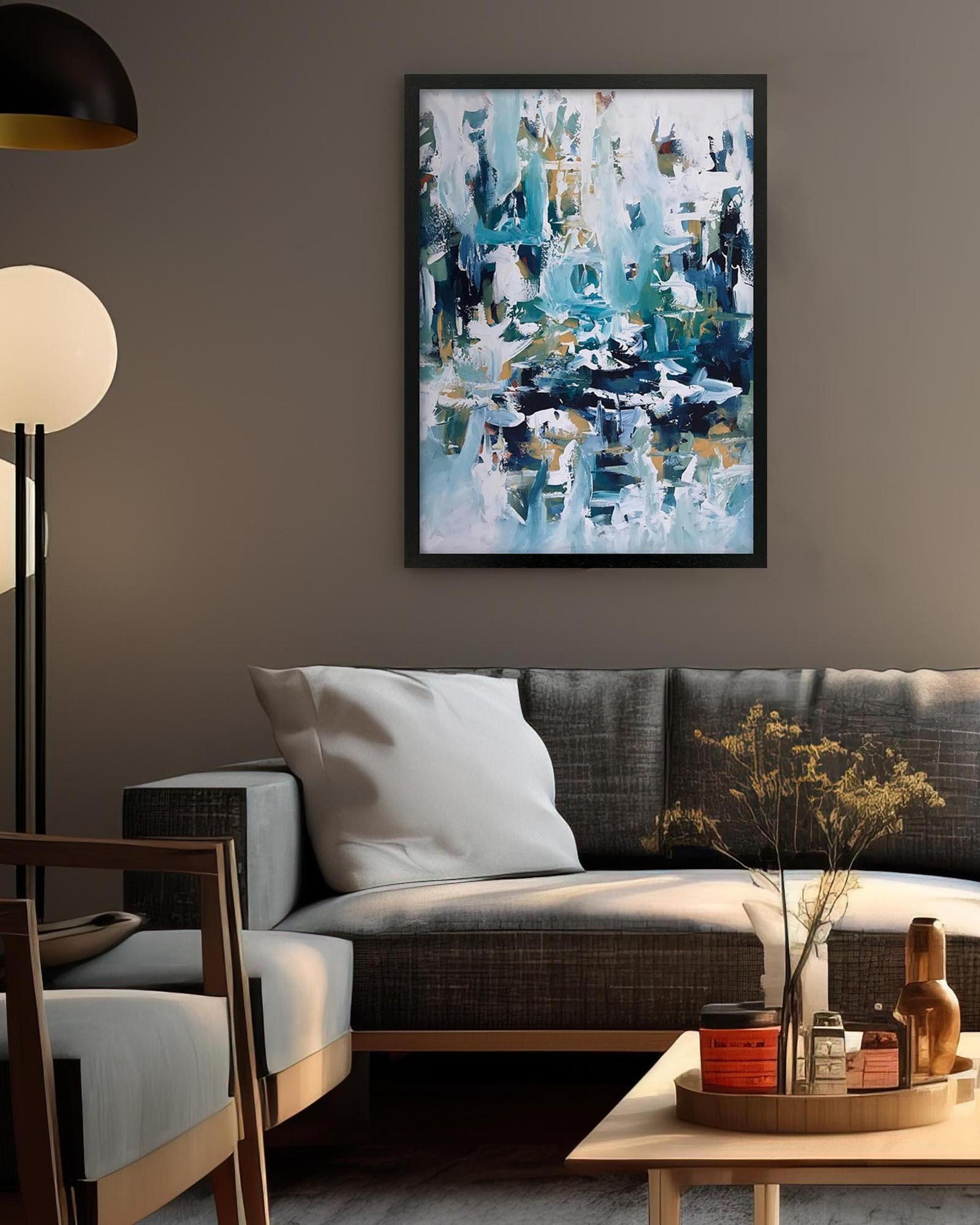 Living room with a gray sofa, abstract art on the wall, and decorative items on a coffee table.