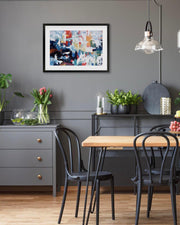 Dining room with a wooden table, black chairs, and abstract art on the wall.