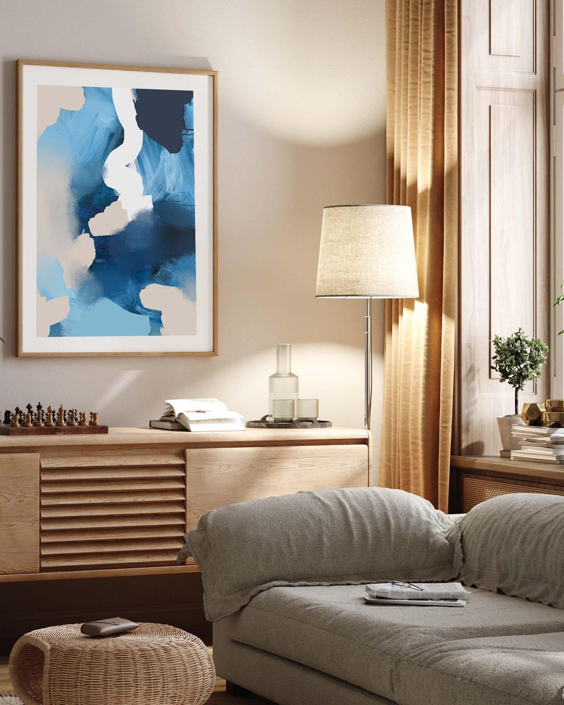 Living room with a gray sofa, wooden sideboard, and abstract art on the wall.