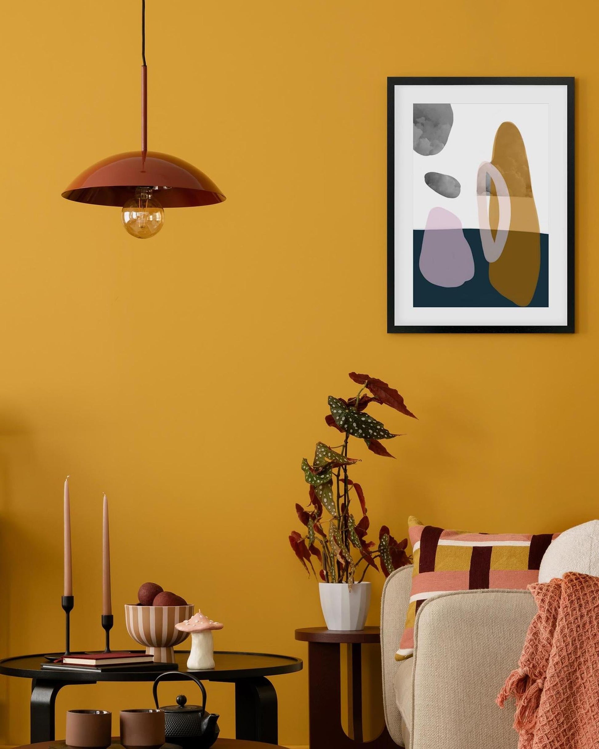 Living room with yellow walls, abstract art, and modern decor