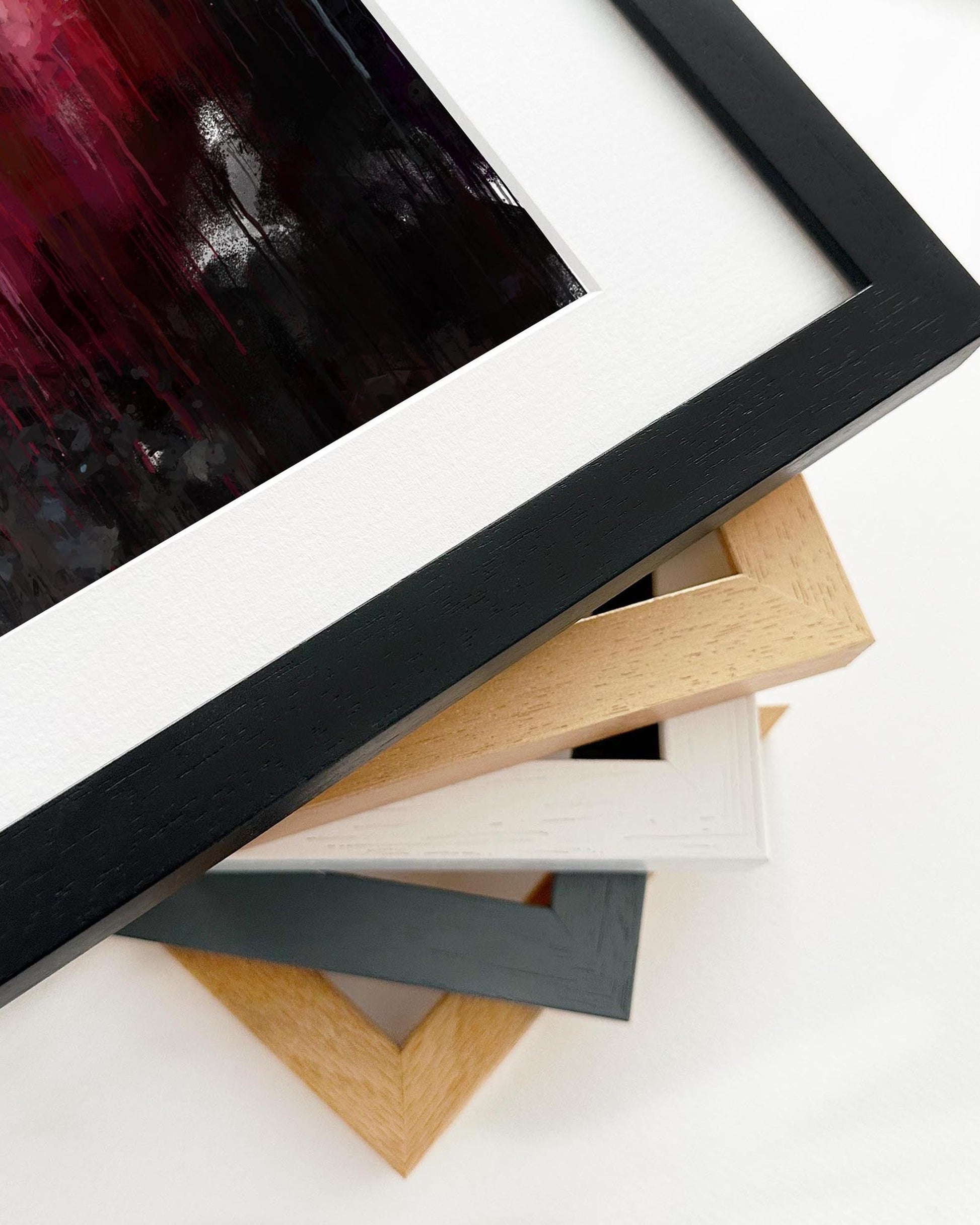 Stack of variously colored picture frames on a white background