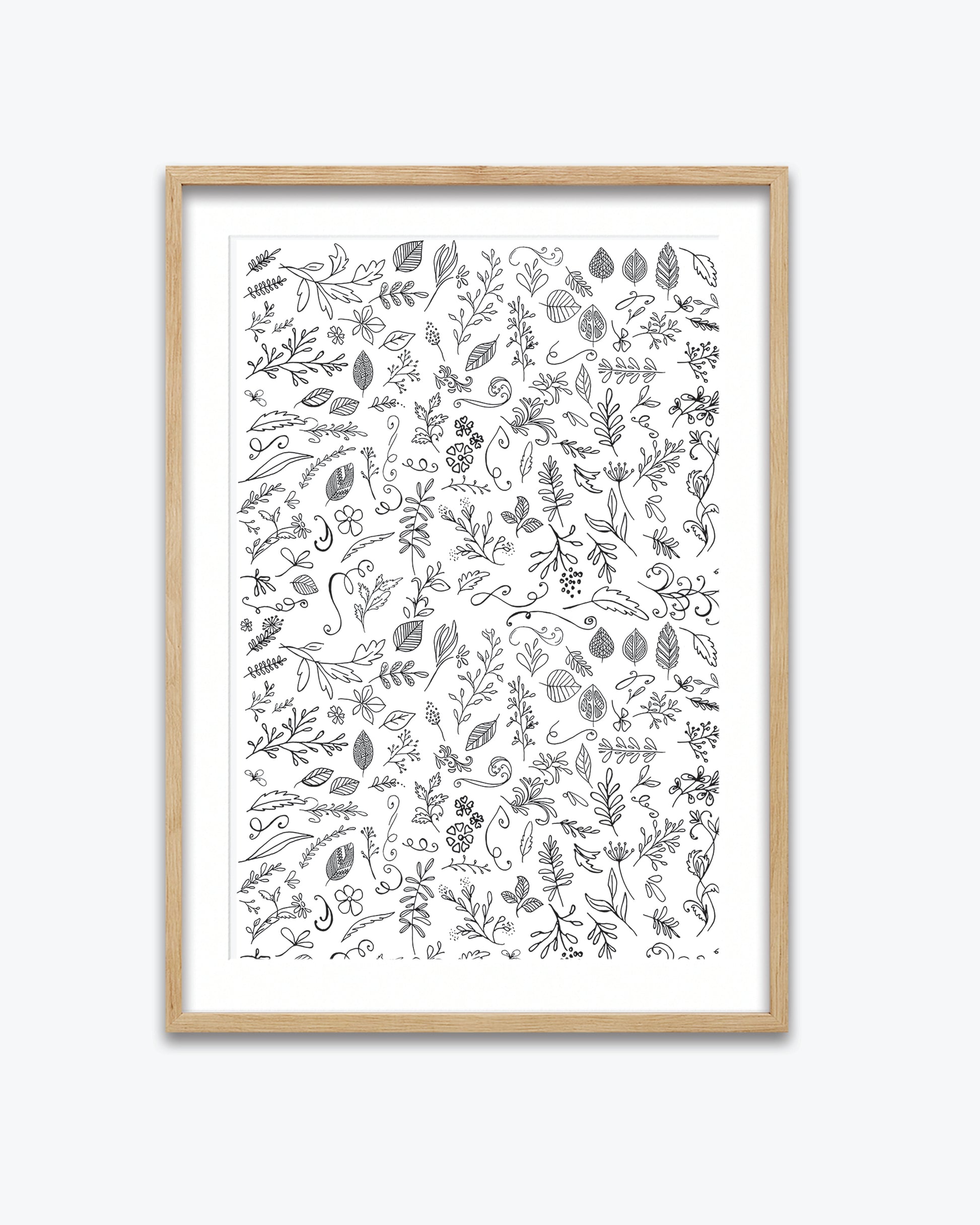 Framed artwork with black and white leaf pattern on a white background