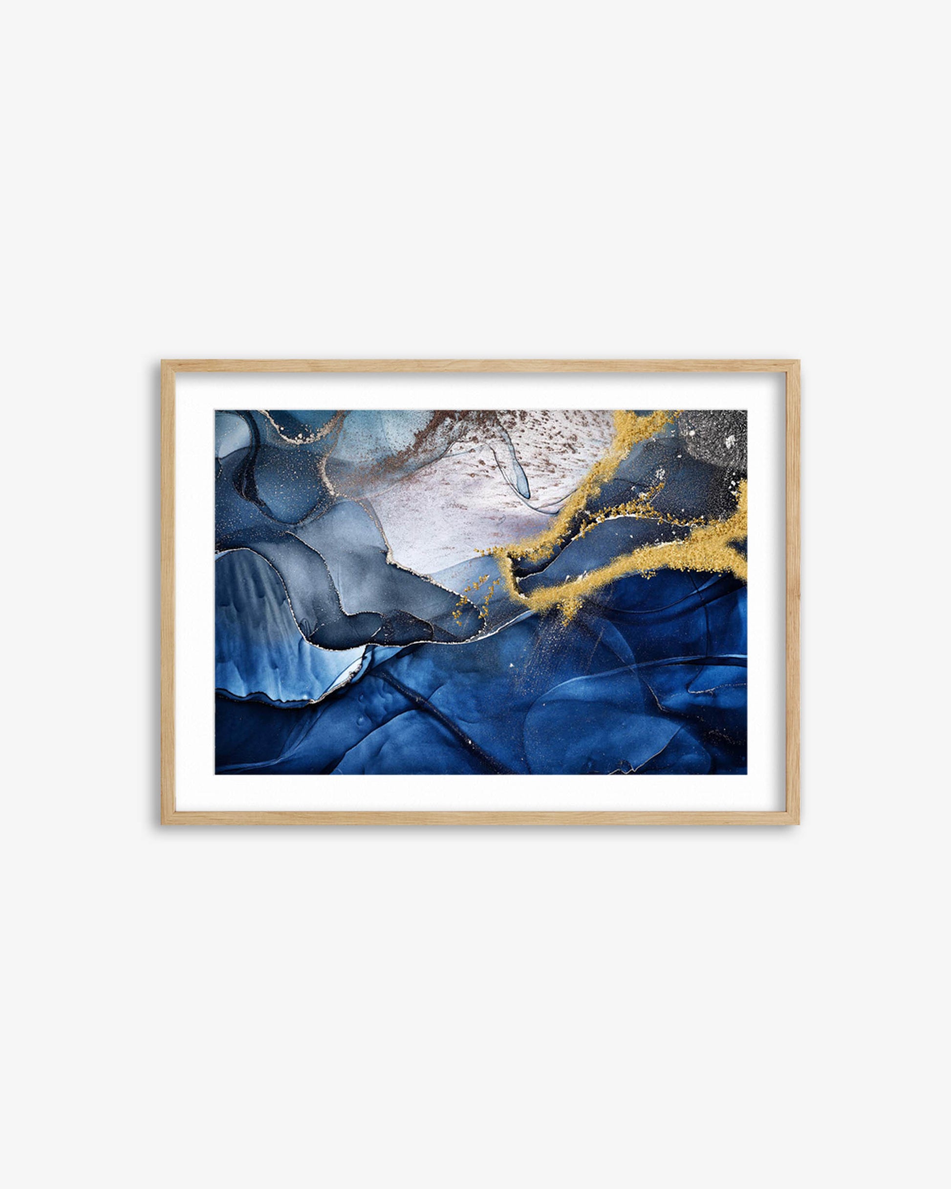Framed abstract art print with blue and gold colors on a white wall