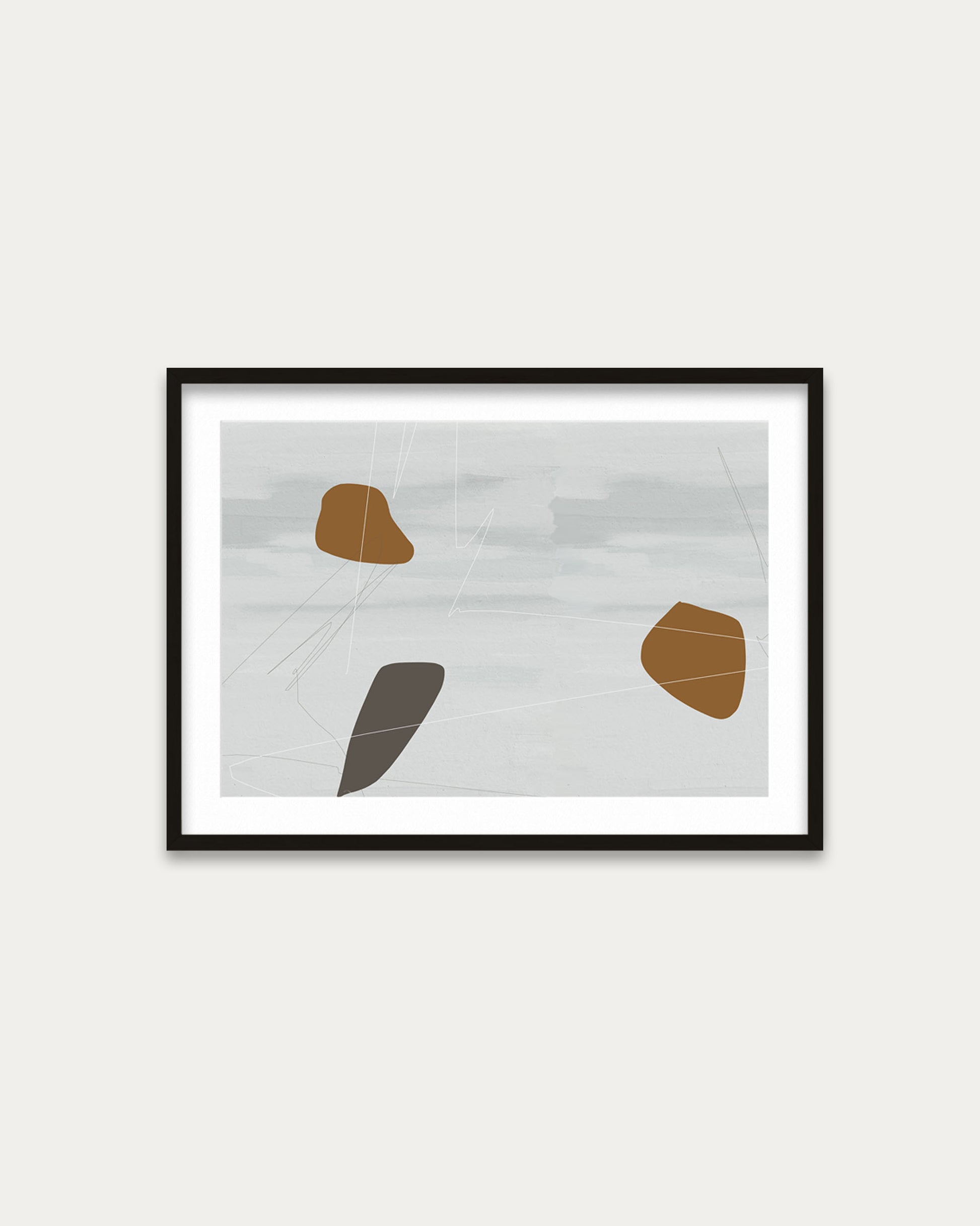 Framed abstract art with geometric shapes on a white wall