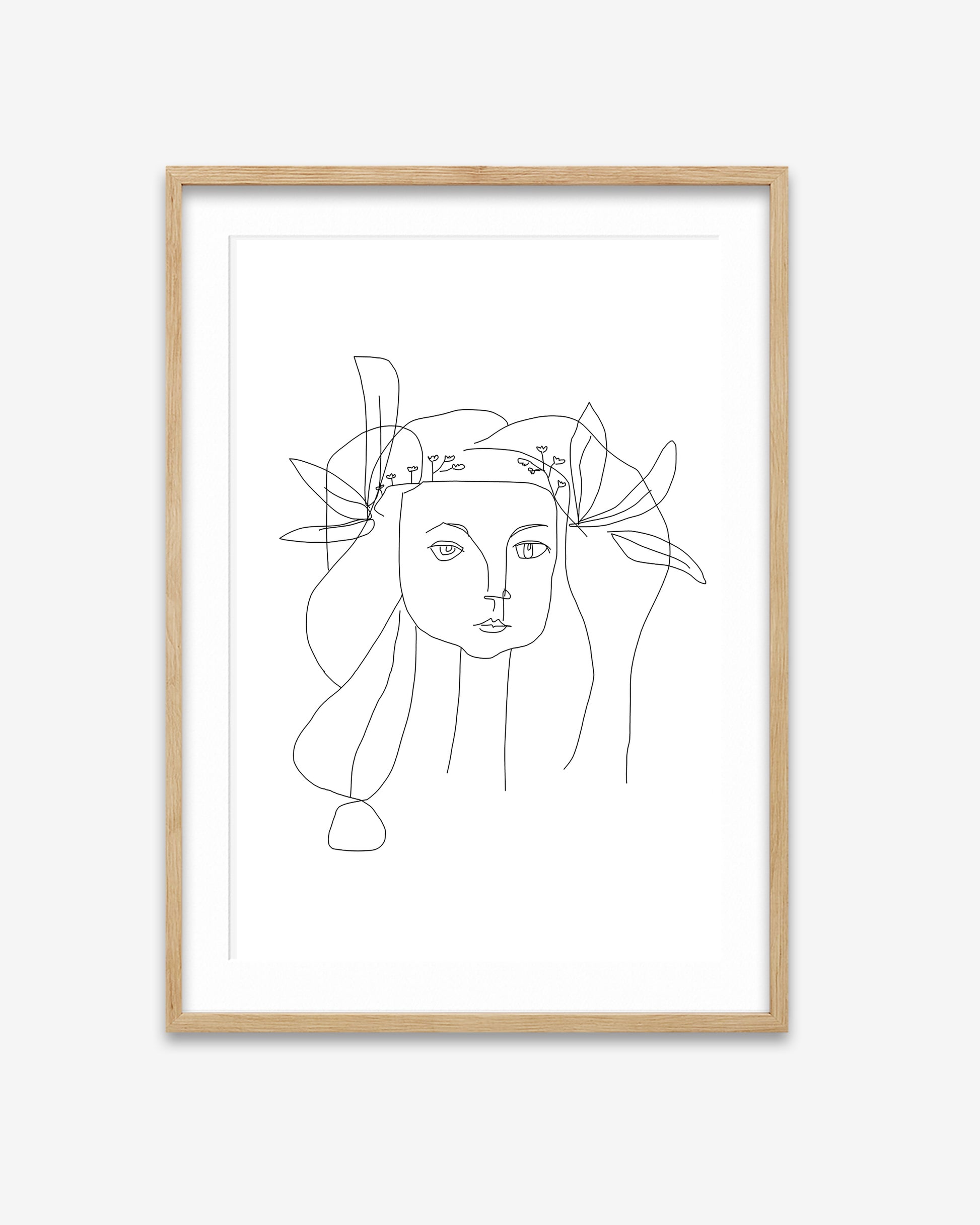 Framed line art of a woman's face with a floral crown on a white background