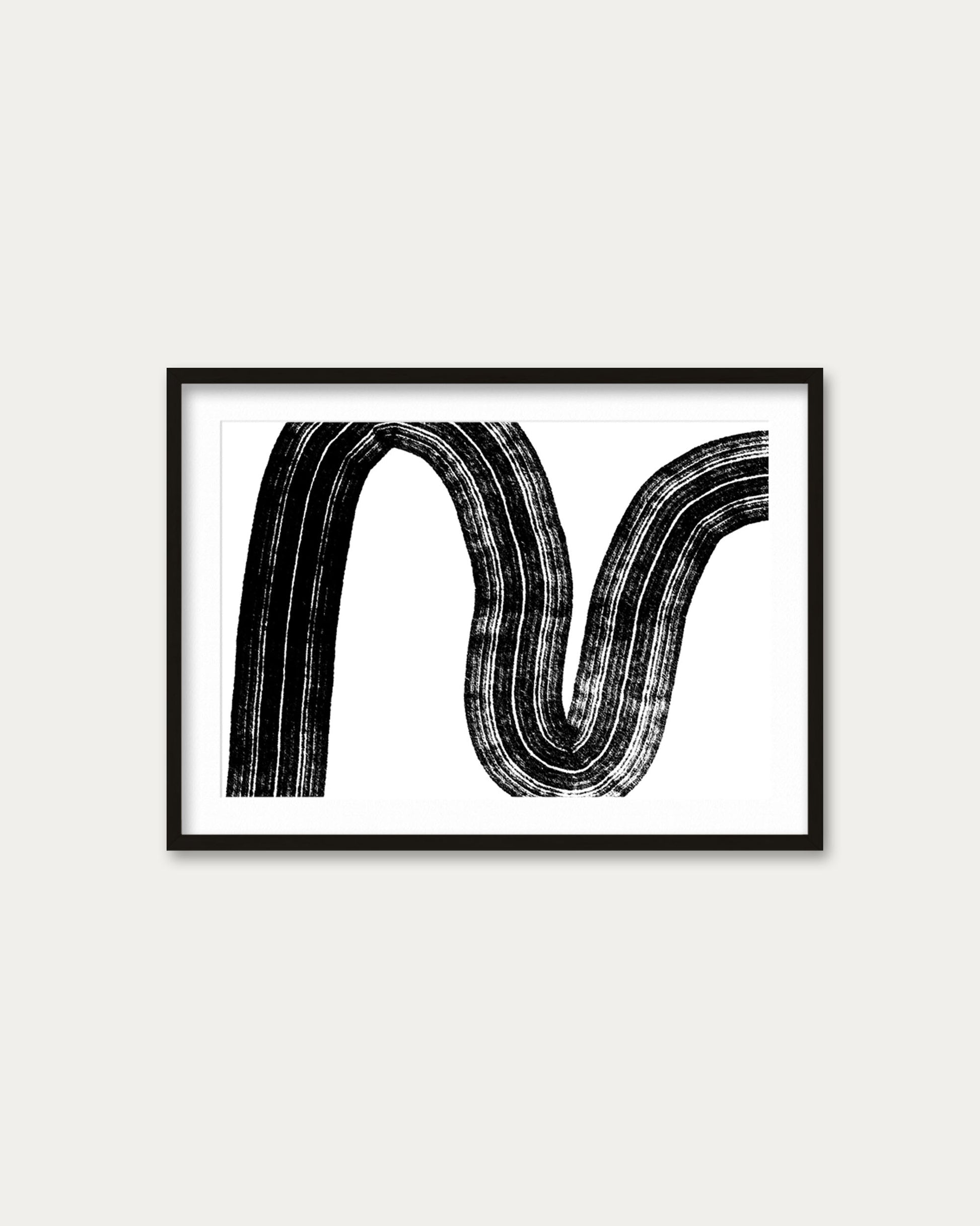 Framed black and white abstract art on a white wall