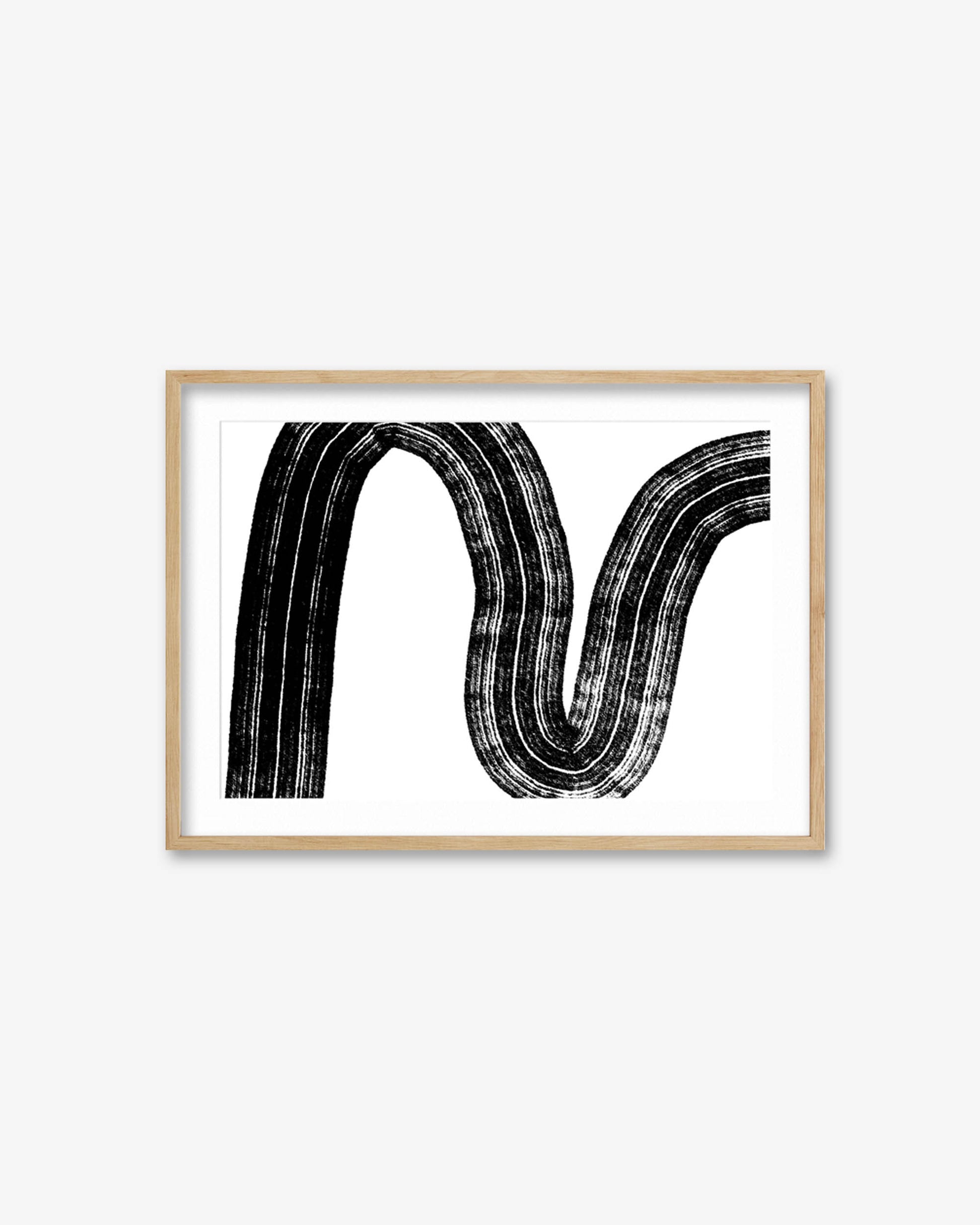 Framed artwork with a black abstract design on a white background