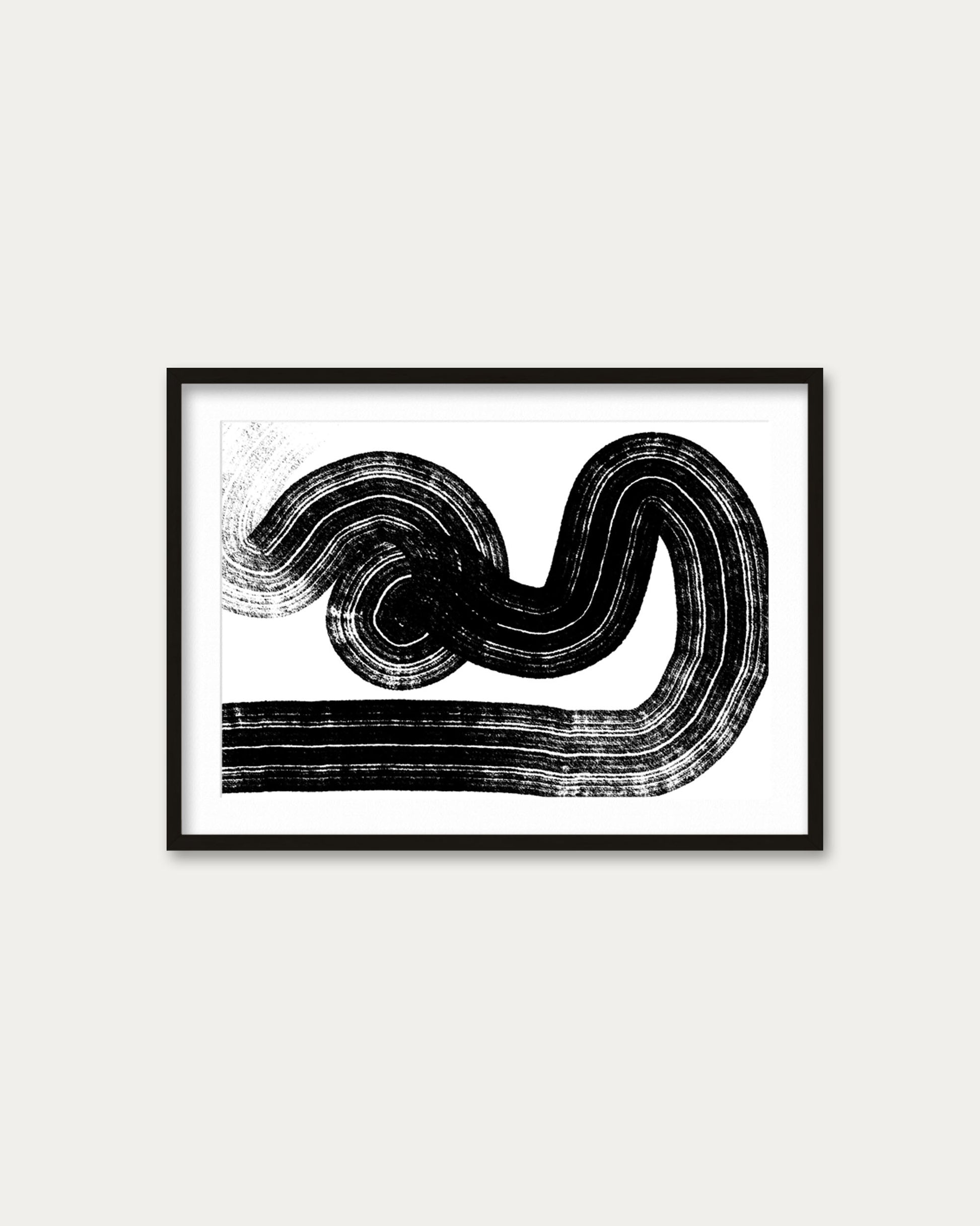 Framed black and white abstract art on a white wall
