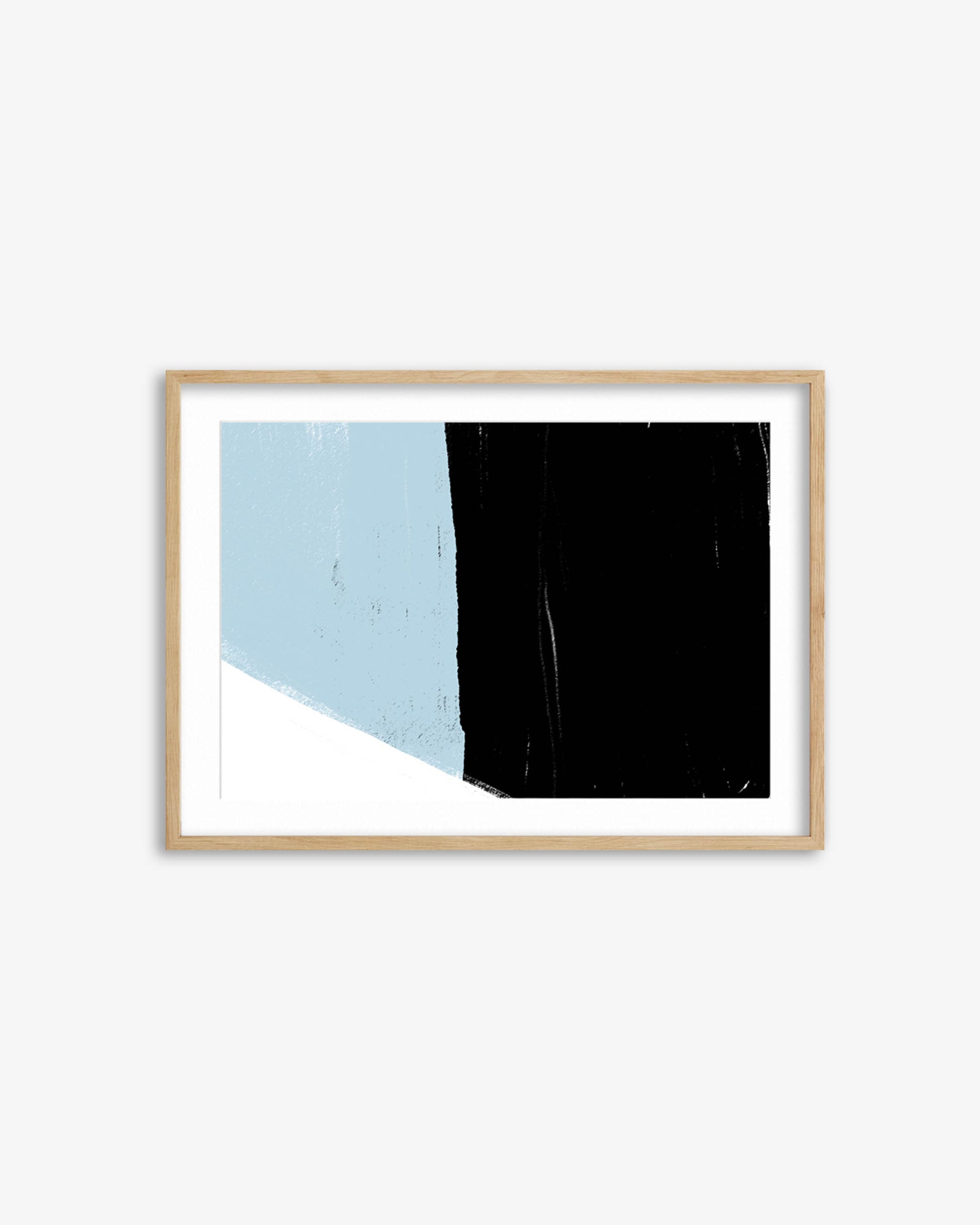 Framed abstract art print with blue, black, and white colors on a white wall.