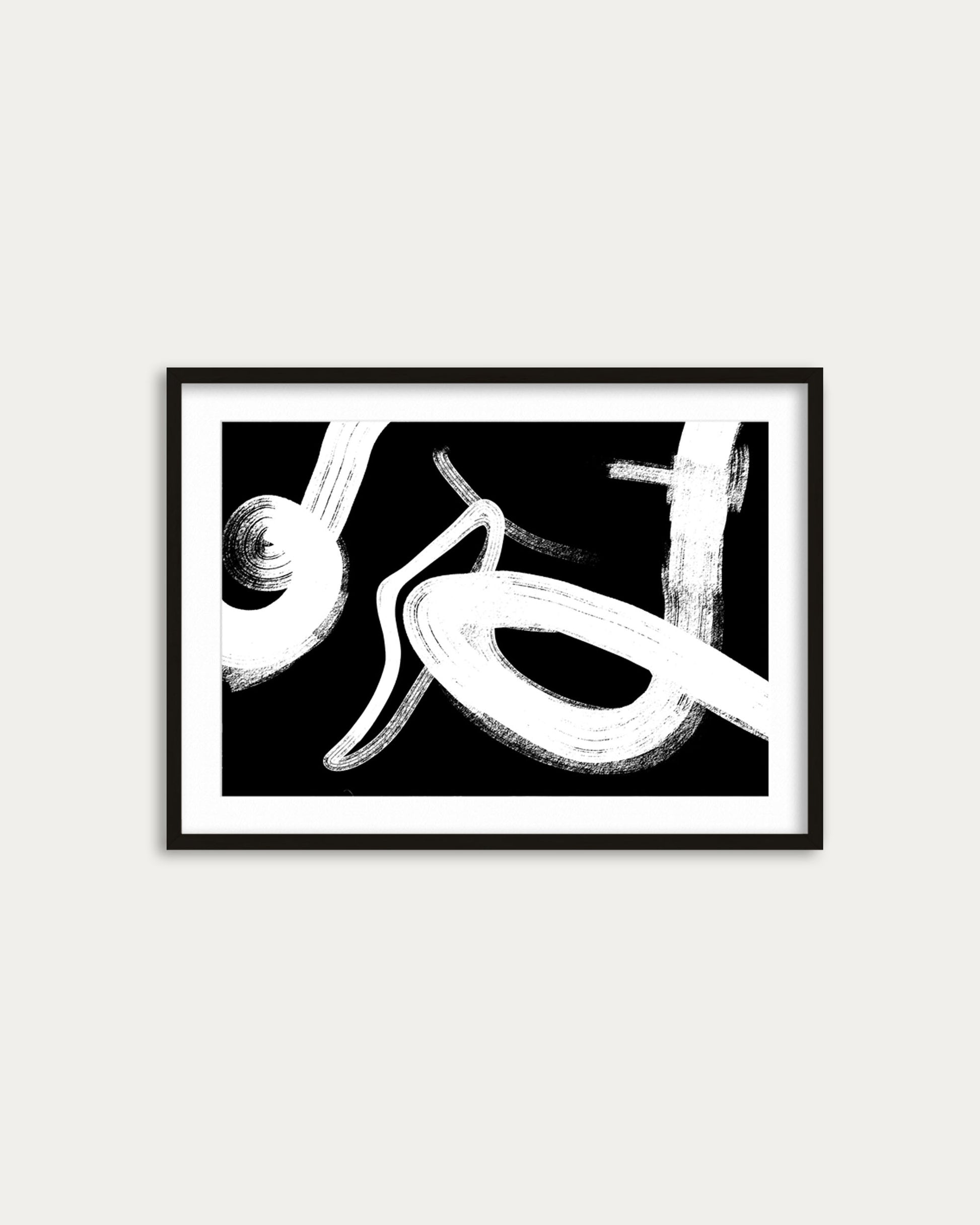 Framed abstract black and white artwork on a white wall