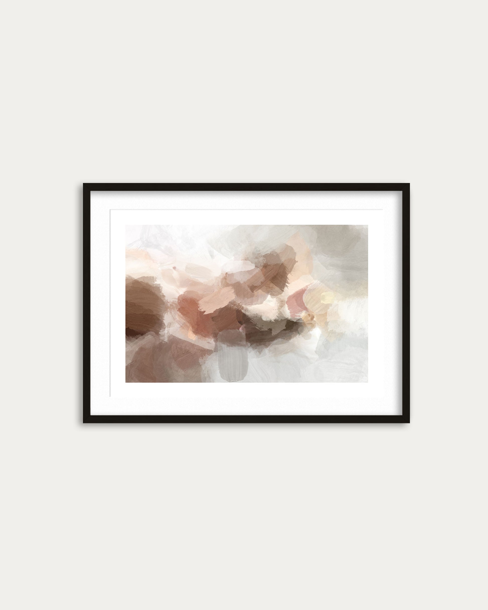 Framed abstract art print with soft colors on a white wall