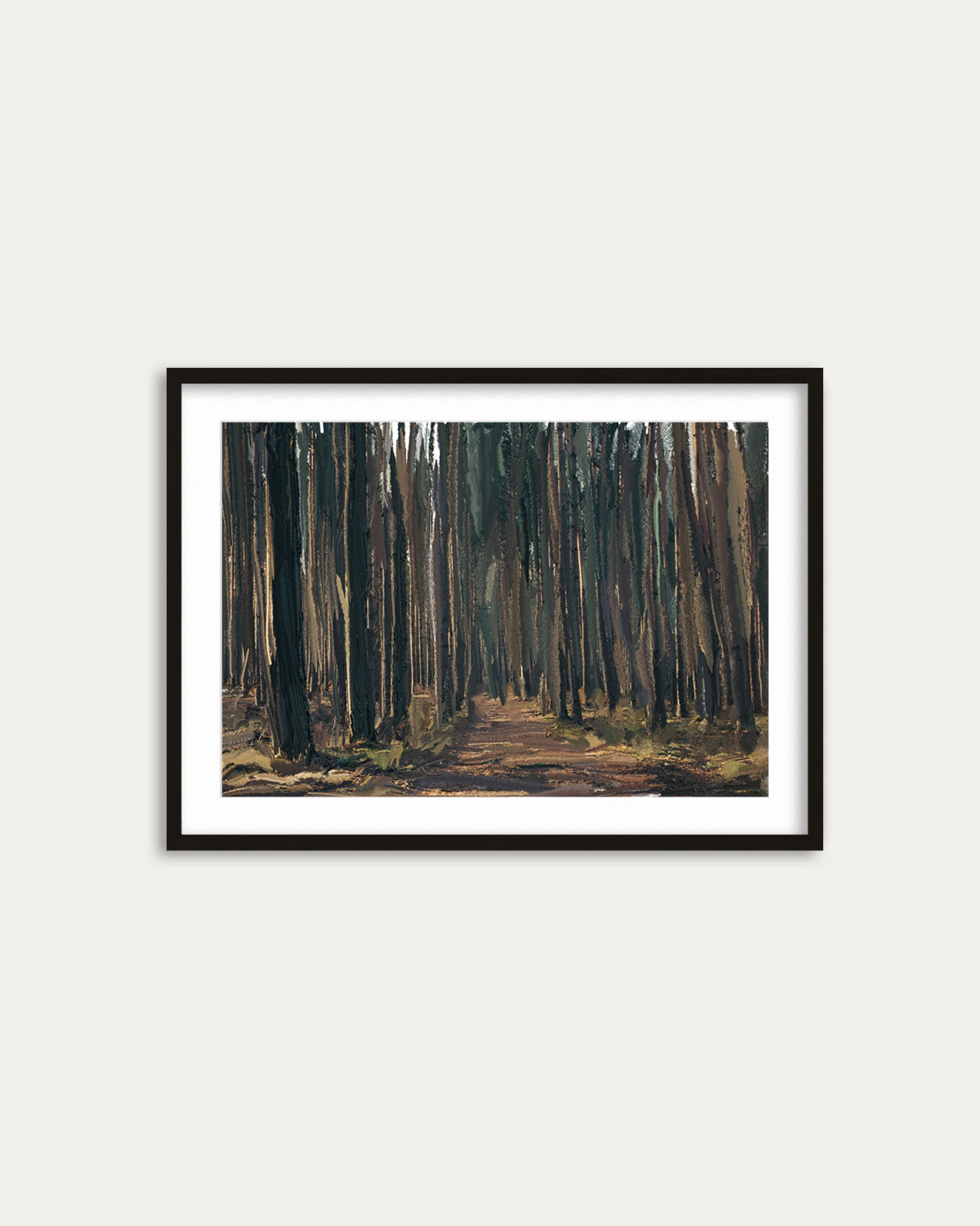 Framed painting of a forest path on a white wall