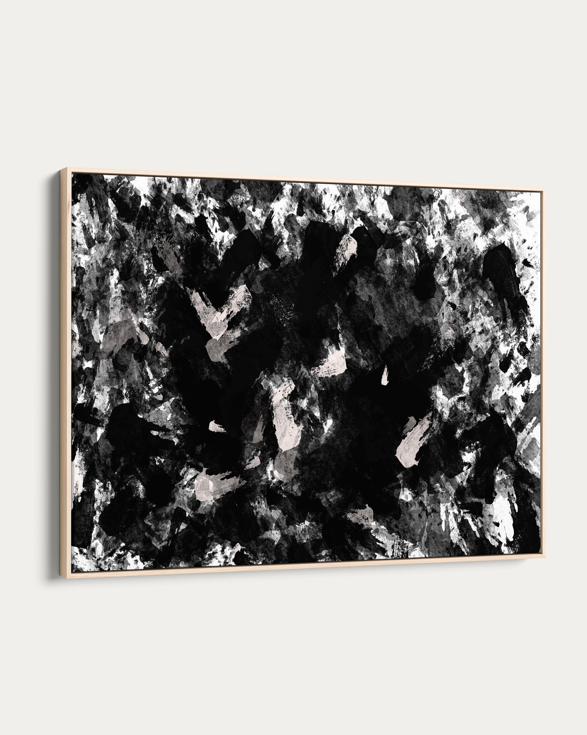 Abstract black and white painting in a wooden frame on a white background