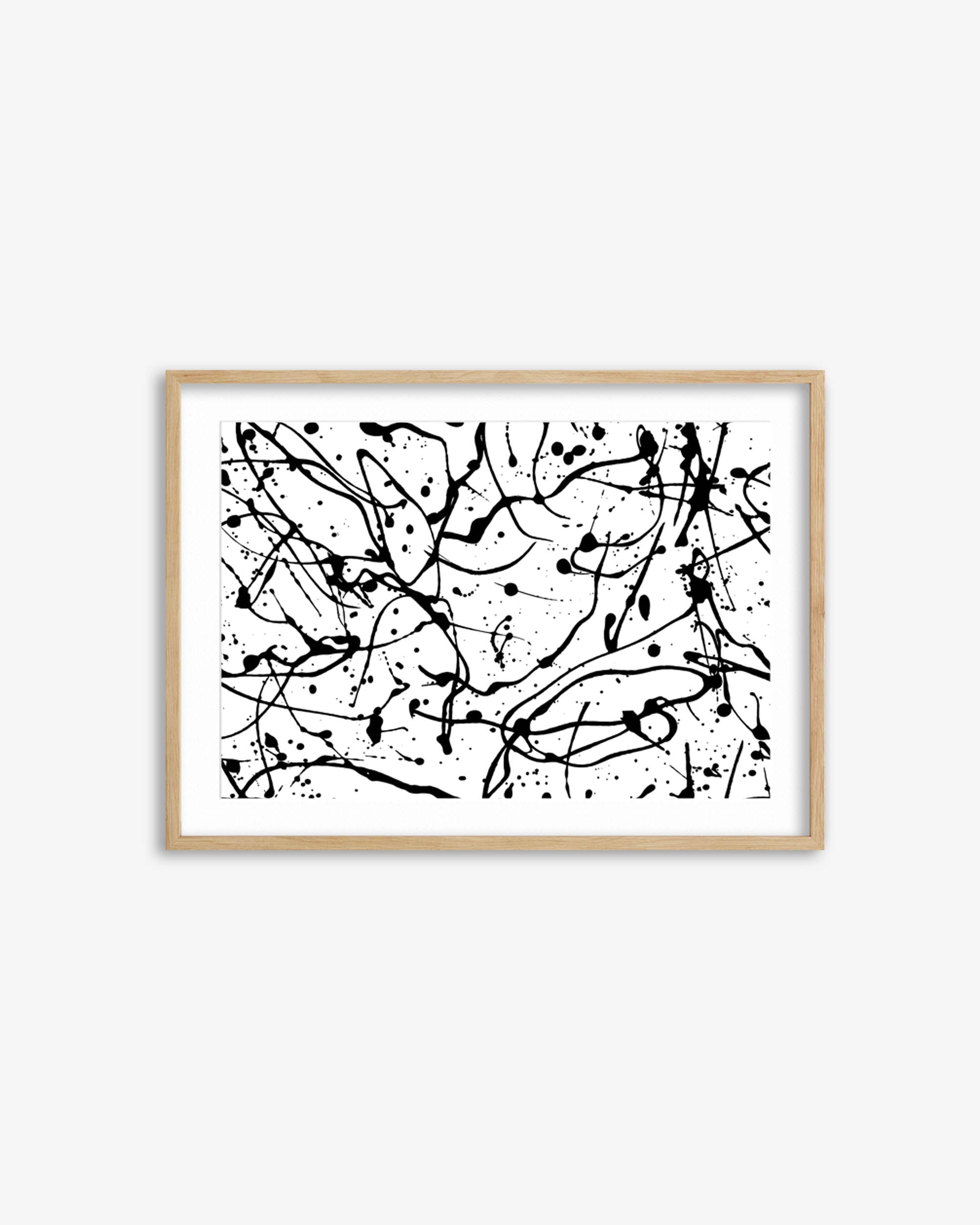 Framed abstract artwork with black splashes on a white background