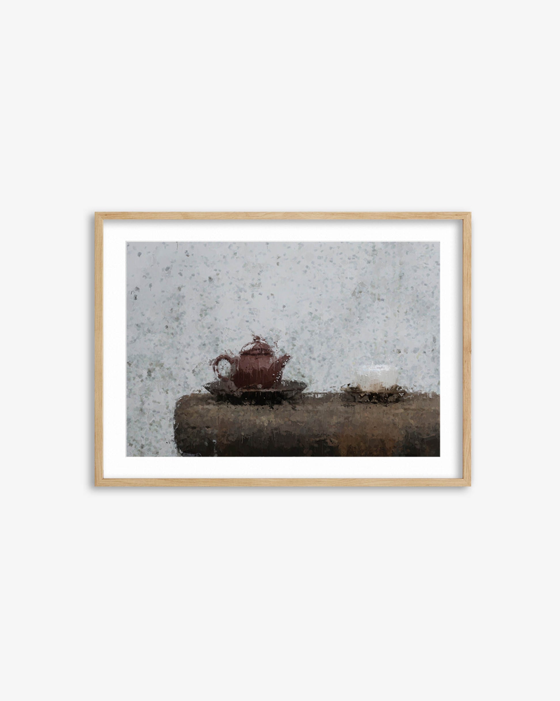 Framed photograph of a red teapot on a stone surface with a textured wall background