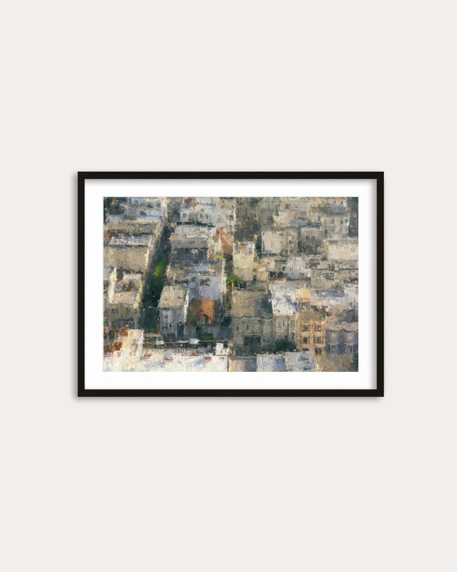 Framed artwork of a cityscape with buildings on a white wall
