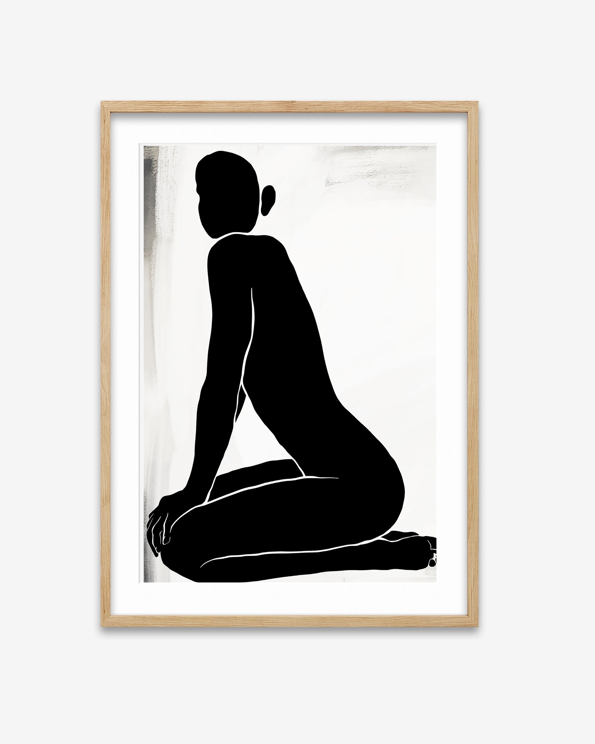 Framed artwork of a black silhouette of a seated figure on a white background