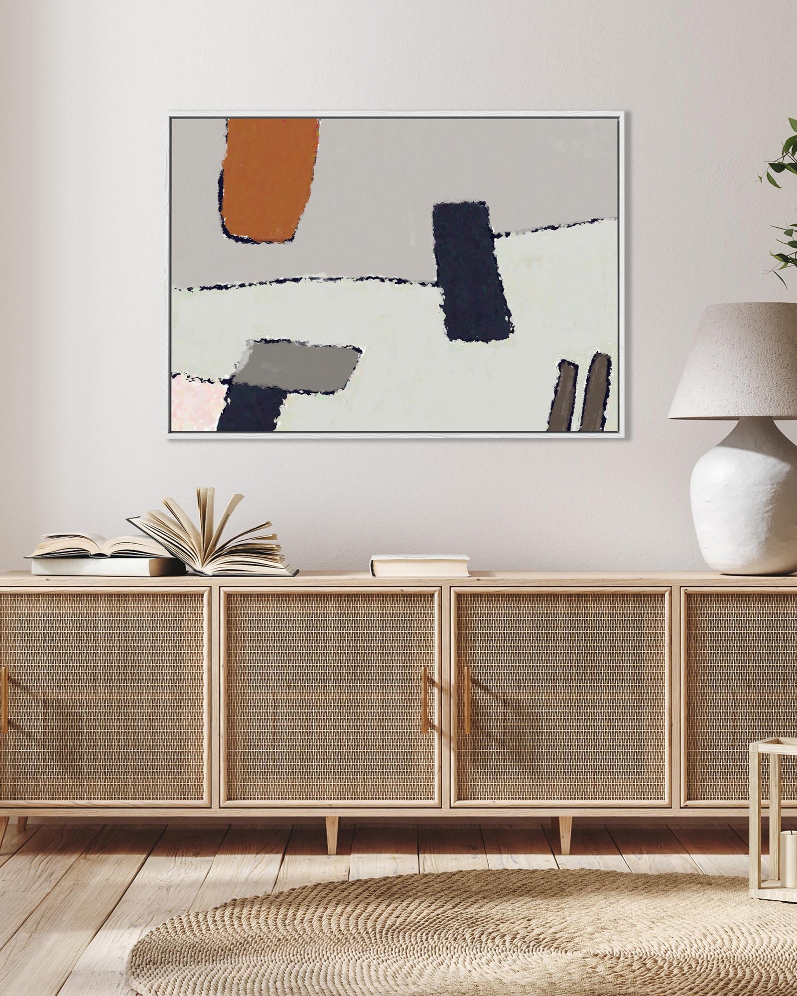 Wooden sideboard with wicker doors in a living room setting, featuring a abstract painting above it.