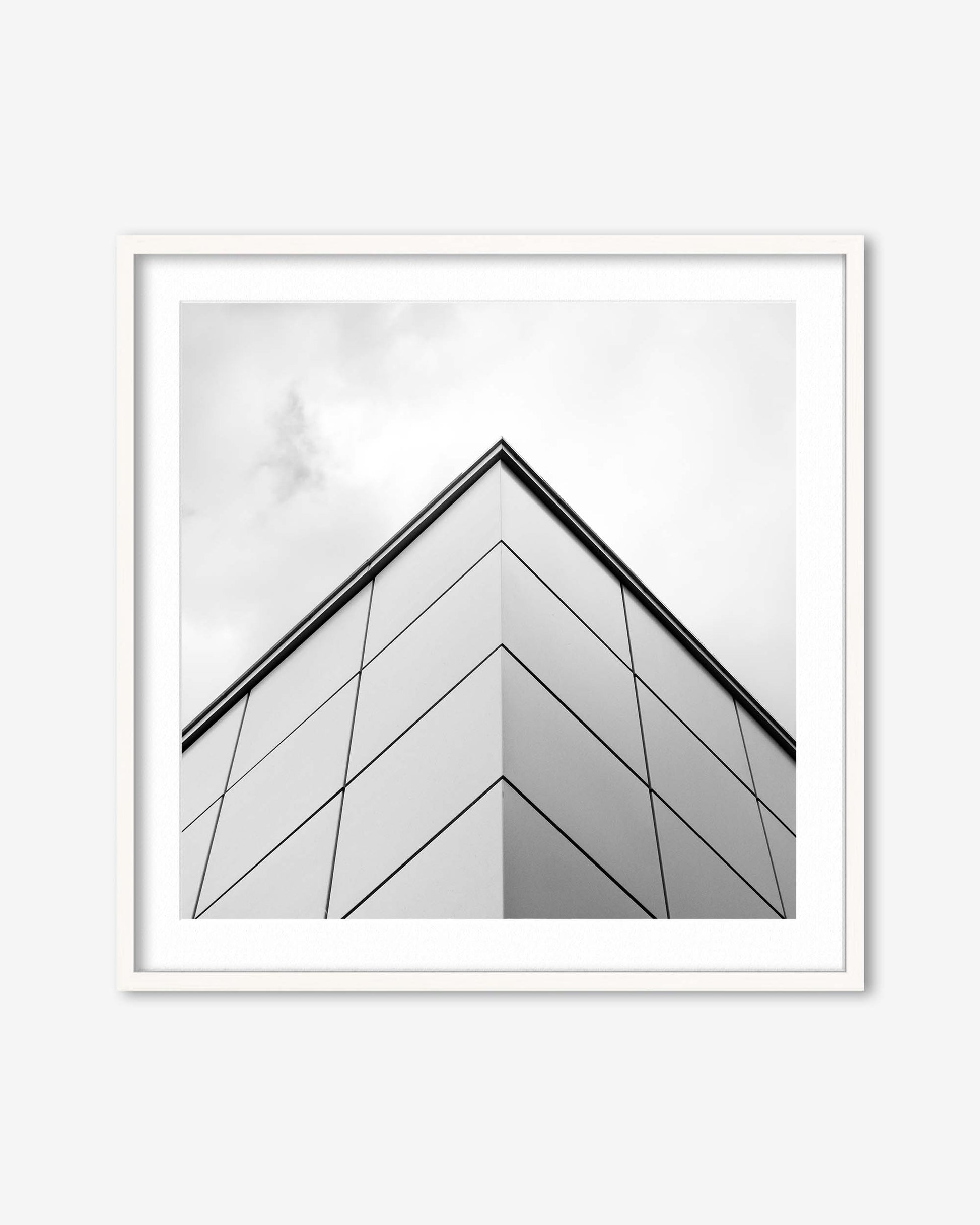 Framed black and white abstract art print on a white wall