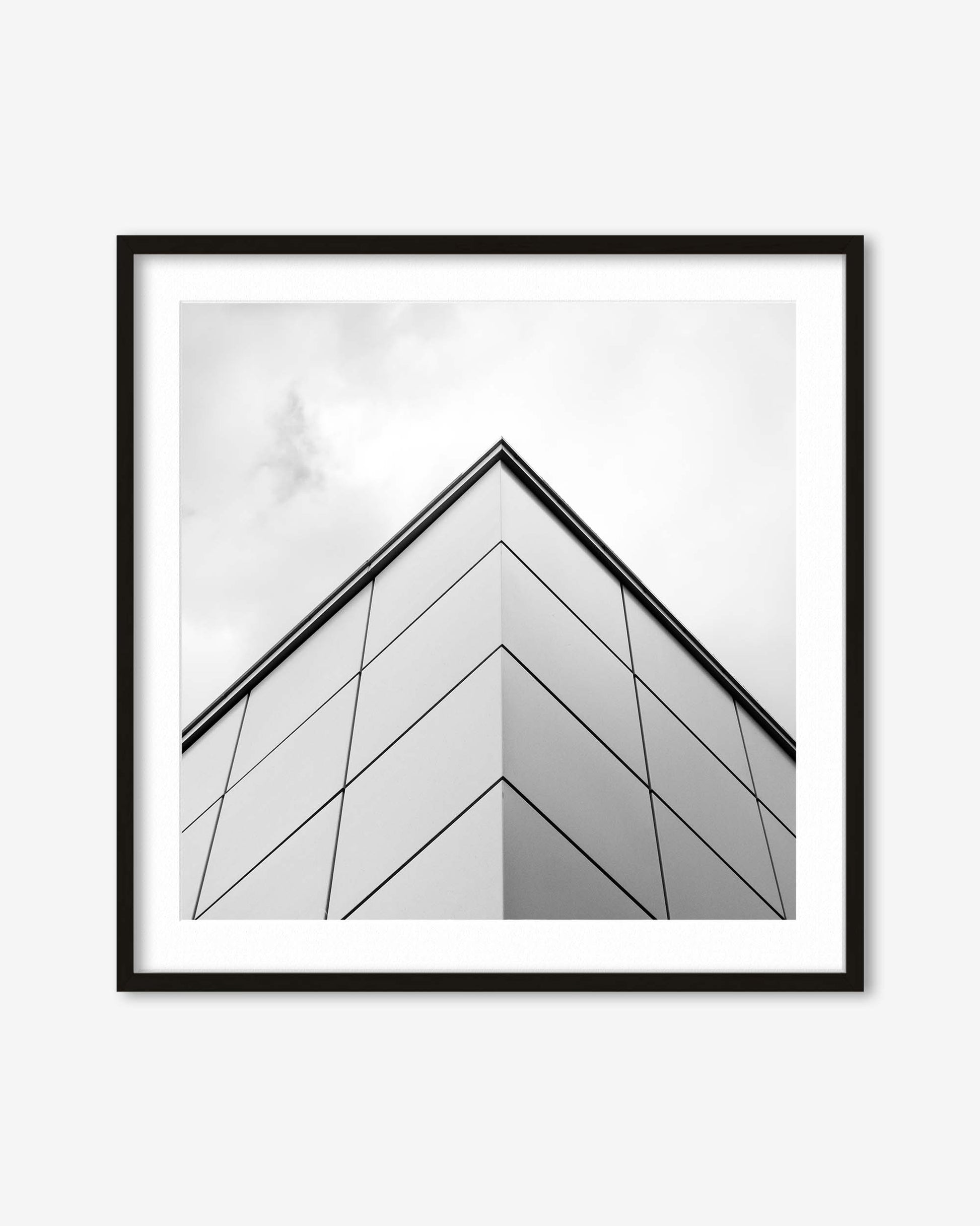 Framed black and white abstract art print on a white wall