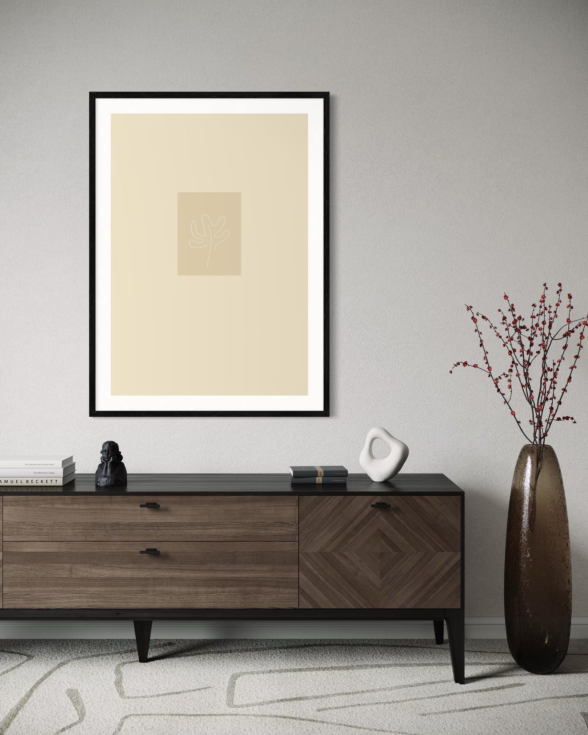 Framed abstract art piece on a wall above a wooden sideboard with decorative items.