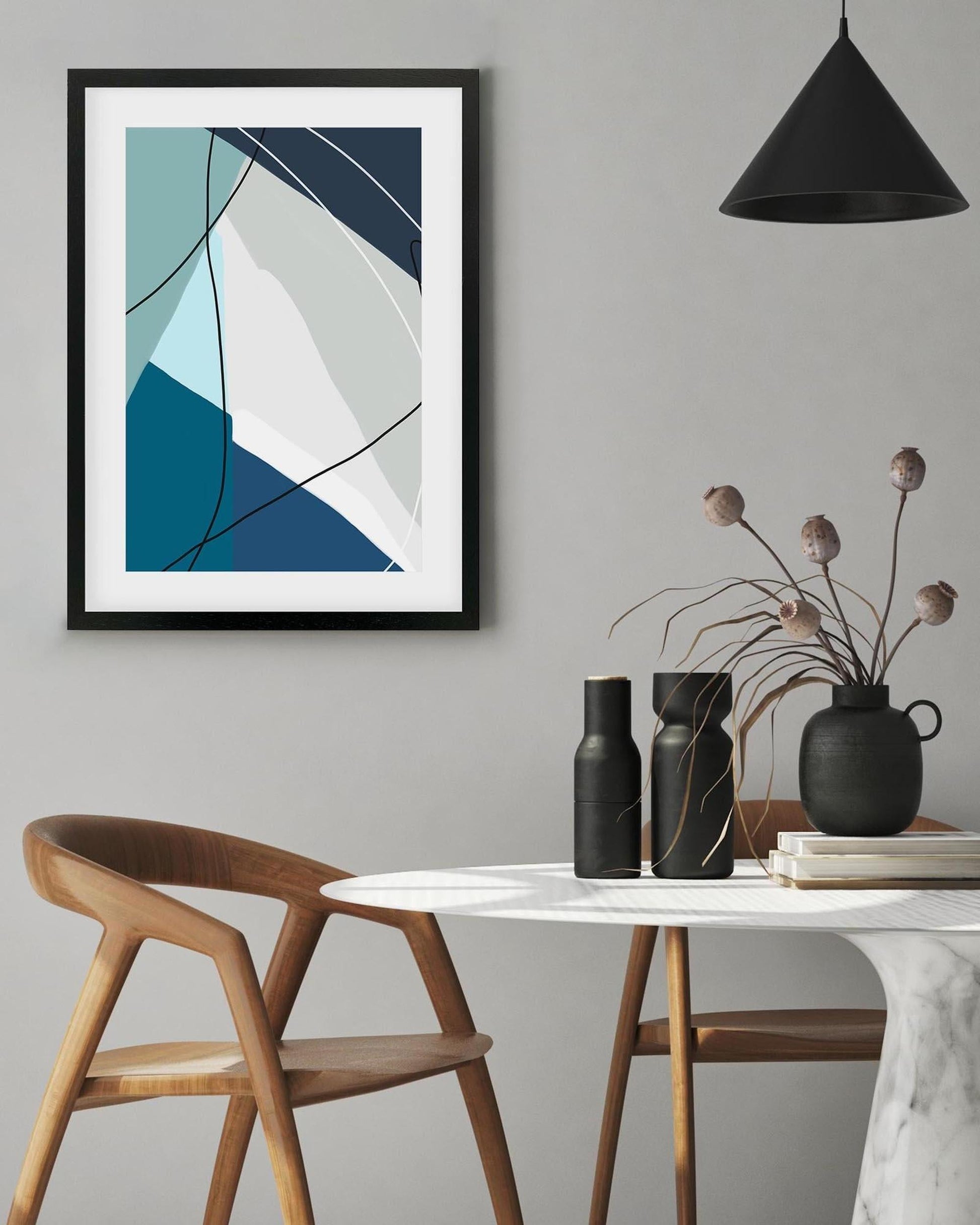 Modern interior with abstract art, wooden chair, and table with decorative items.