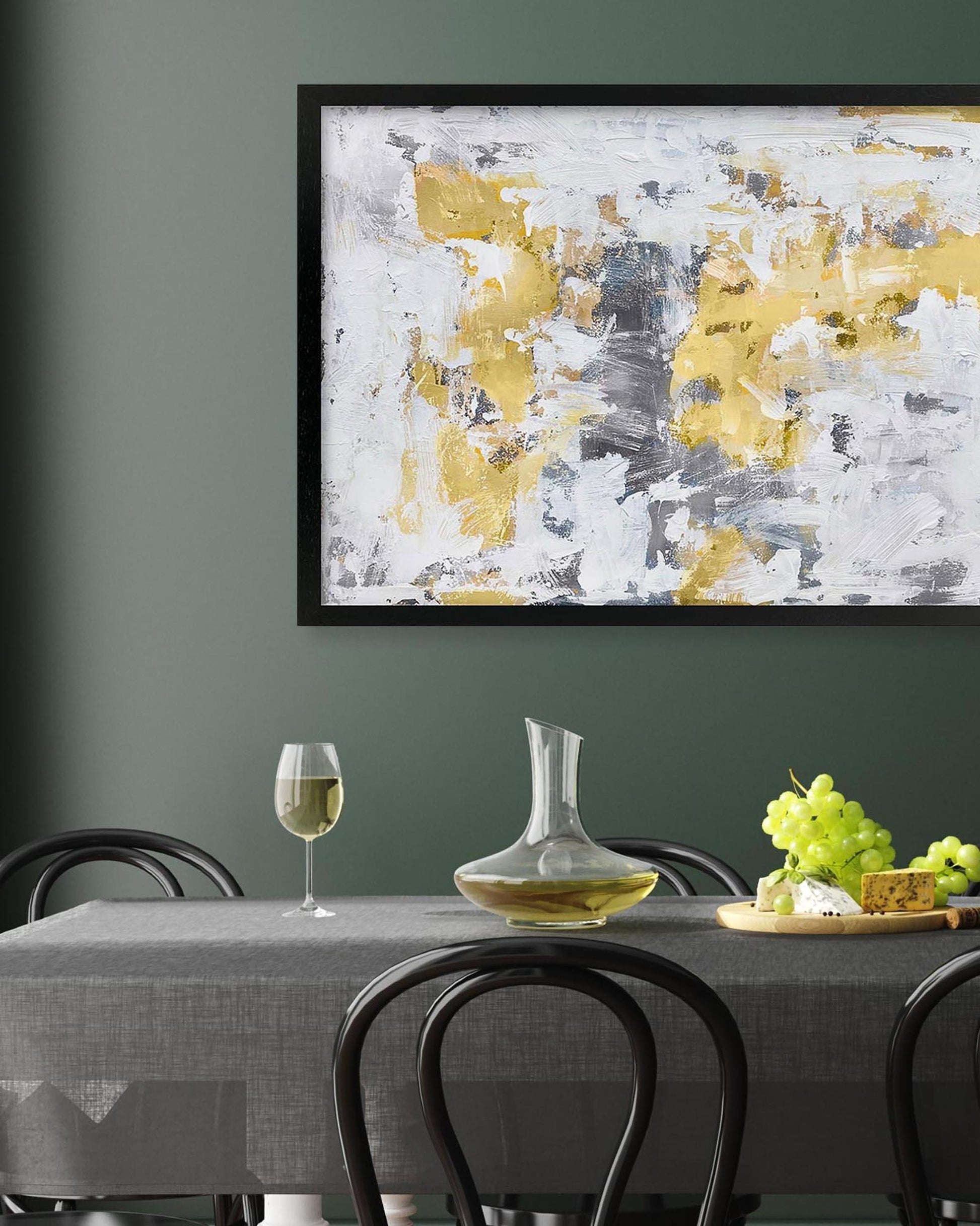 Dining room with abstract art on the wall, table set with wine and decanter.