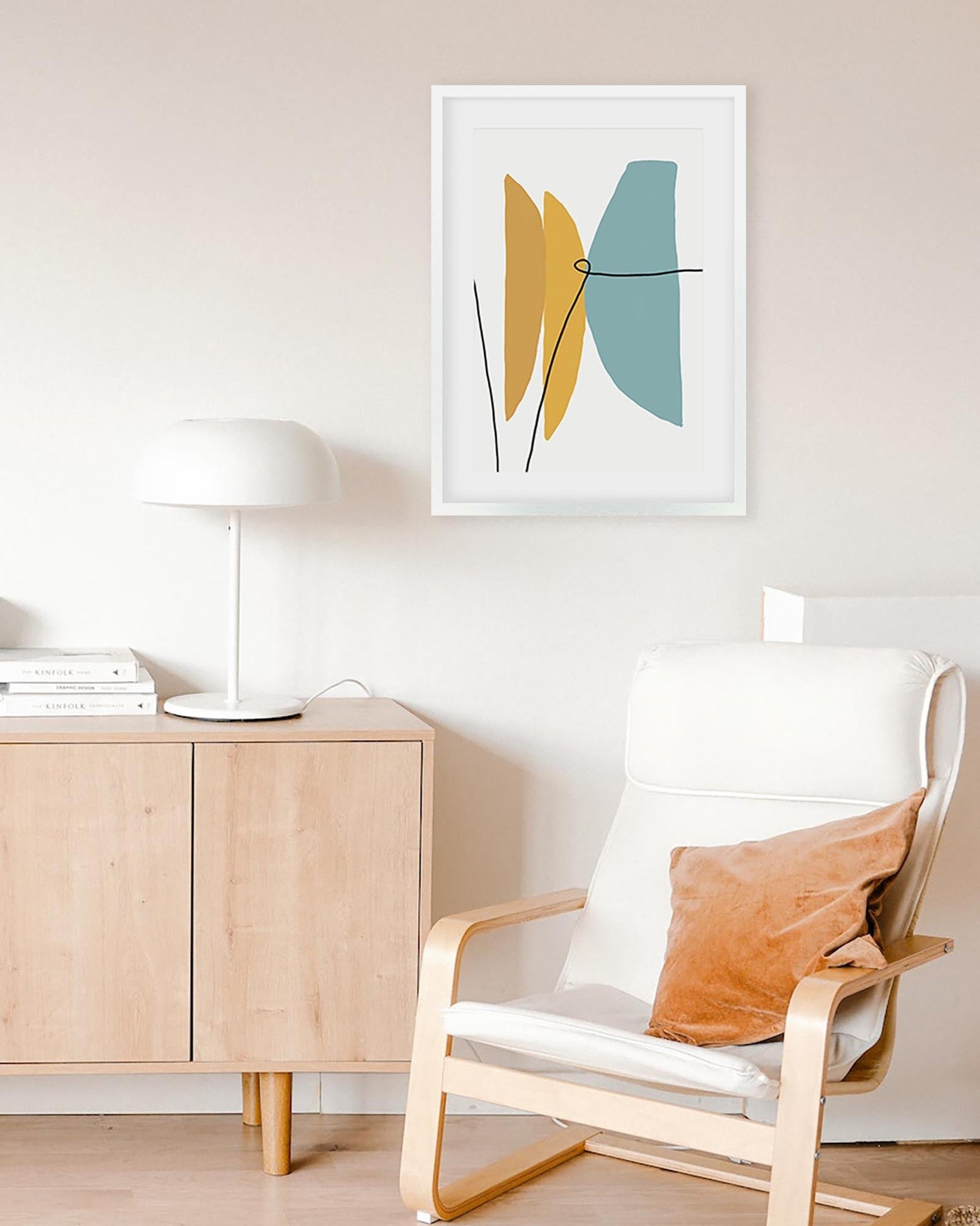 Modern interior with a chair, sideboard, and abstract art on the wall.