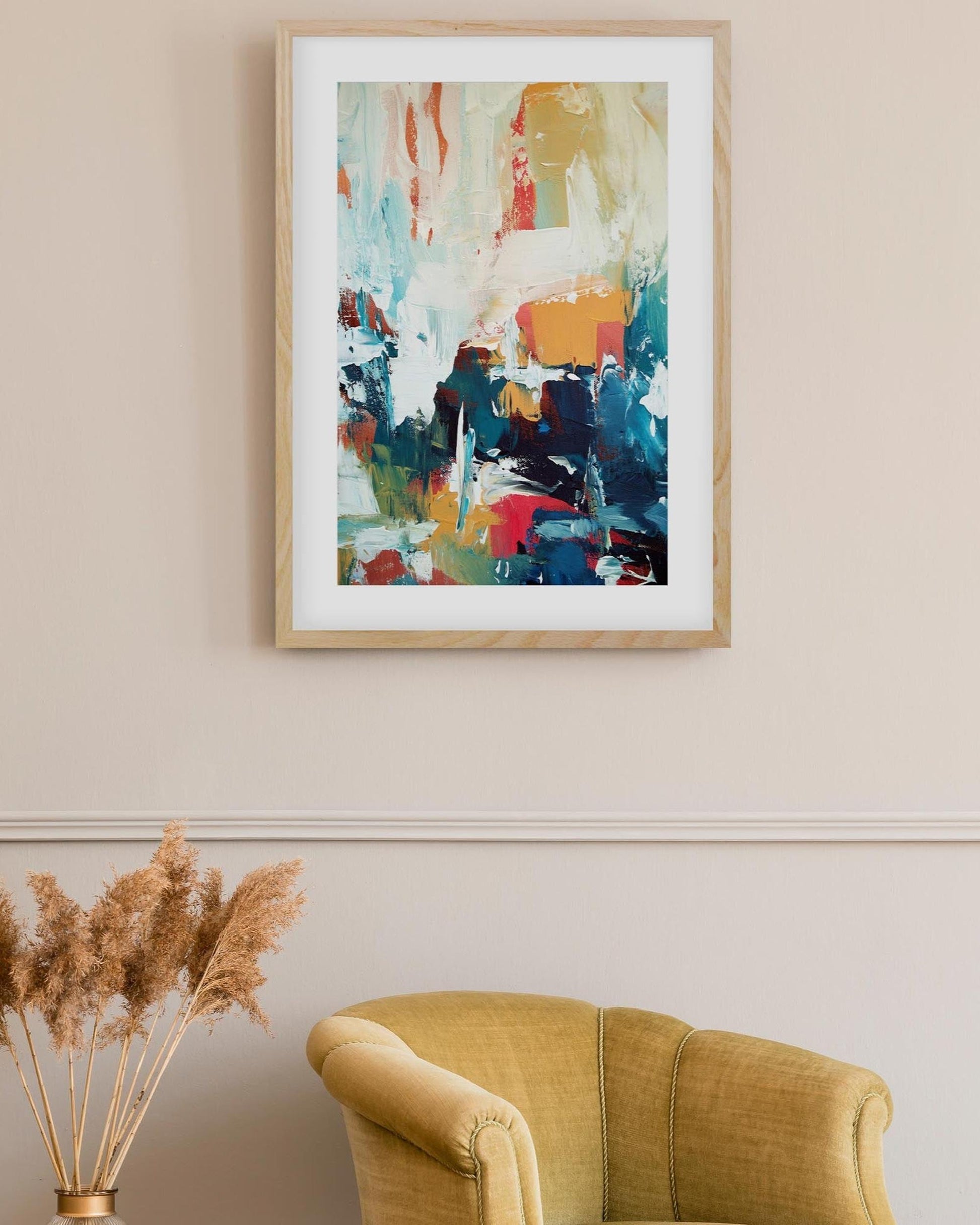 Abstract painting on a wall above a yellow armchair with decorative elements.