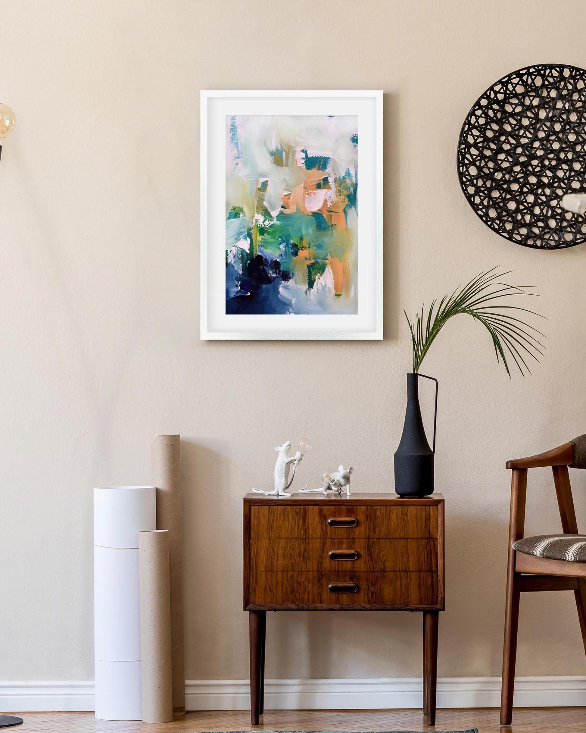 Modern interior with abstract art, wooden cabinet, and decorative elements.