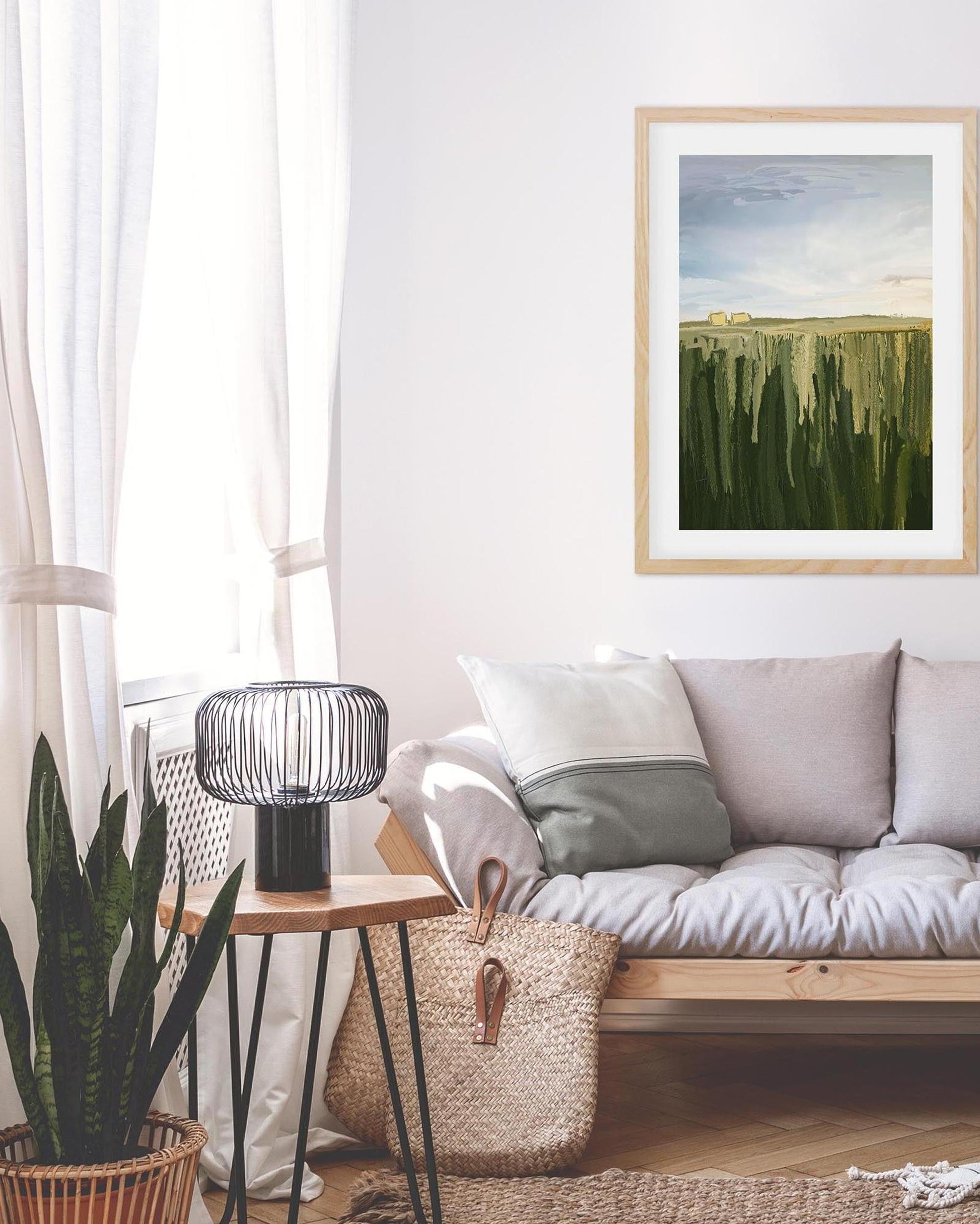 Living room with a sofa, side table, and framed artwork on the wall.