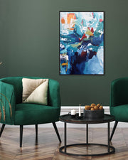 Modern living room with green armchairs, a small round table, and abstract art on the wall.