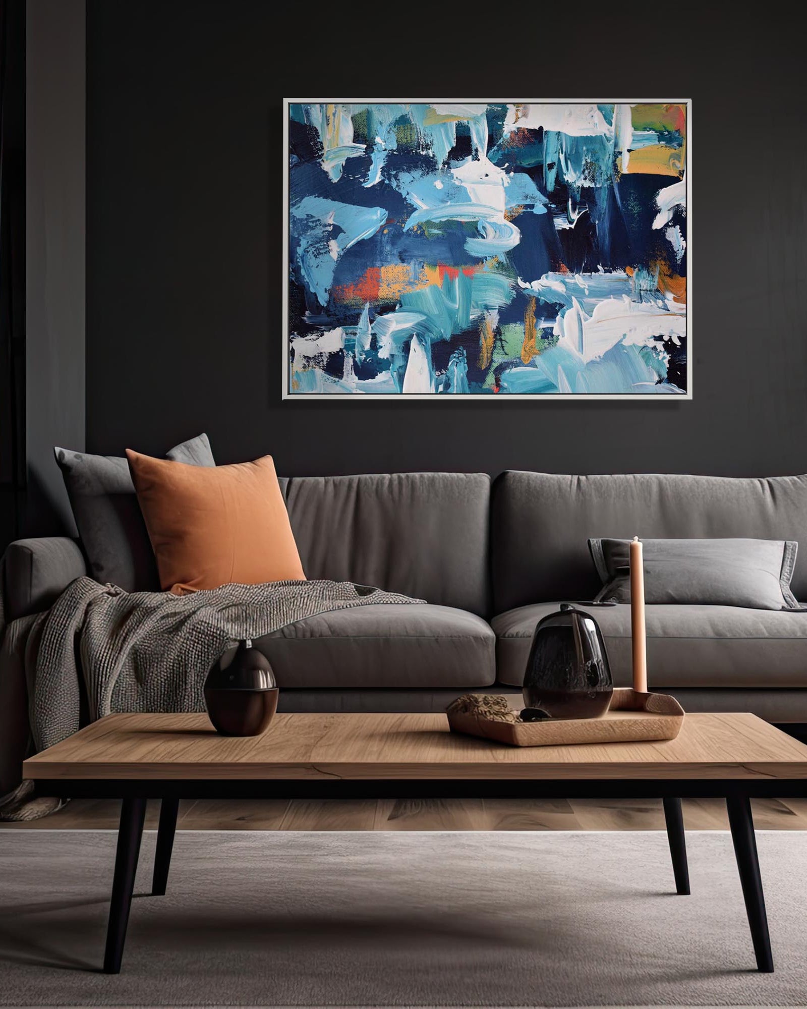 Living room with a gray sofa, wooden coffee table, and abstract art on the wall.