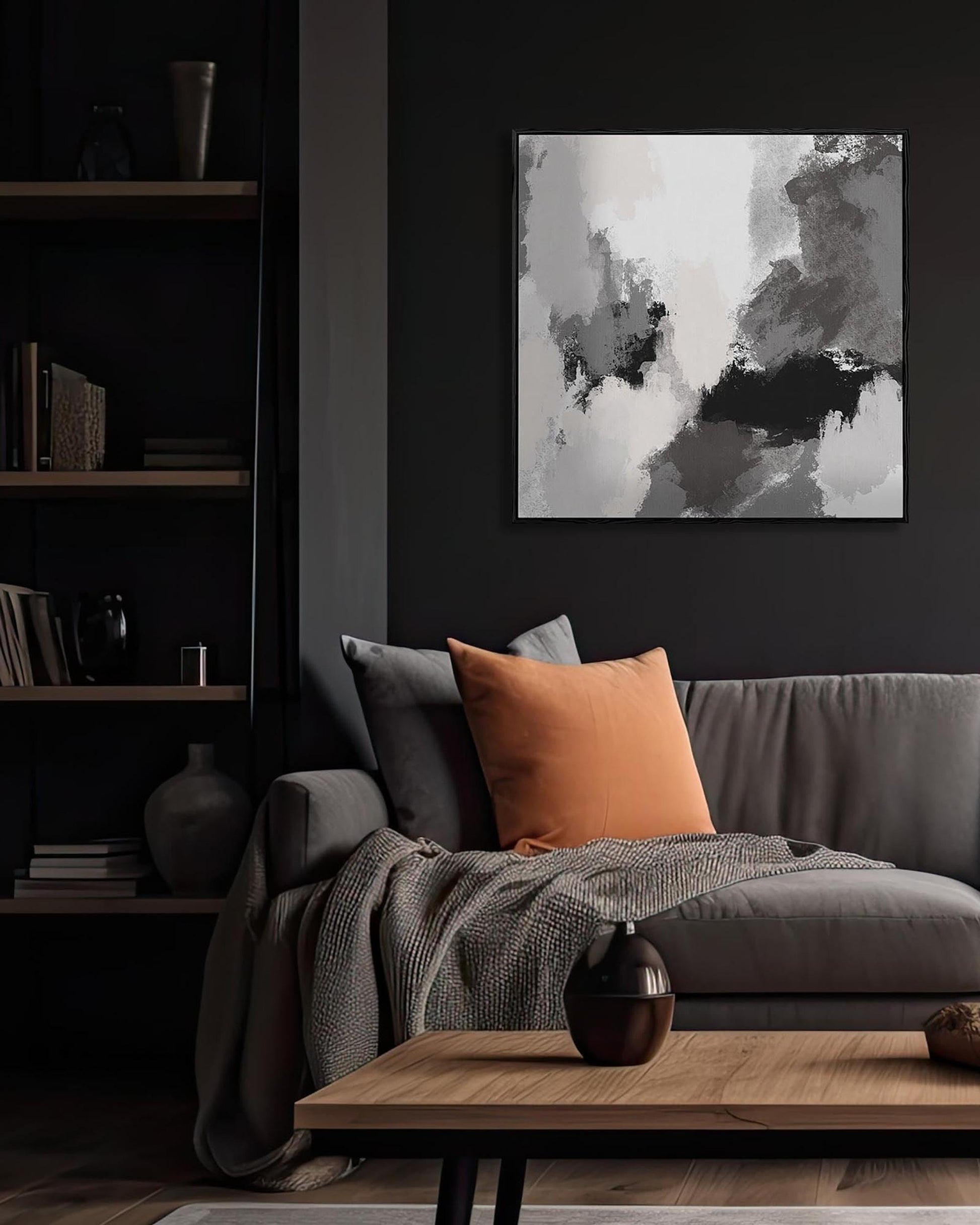 Living room with a gray sofa, orange pillow, and abstract art on the wall.