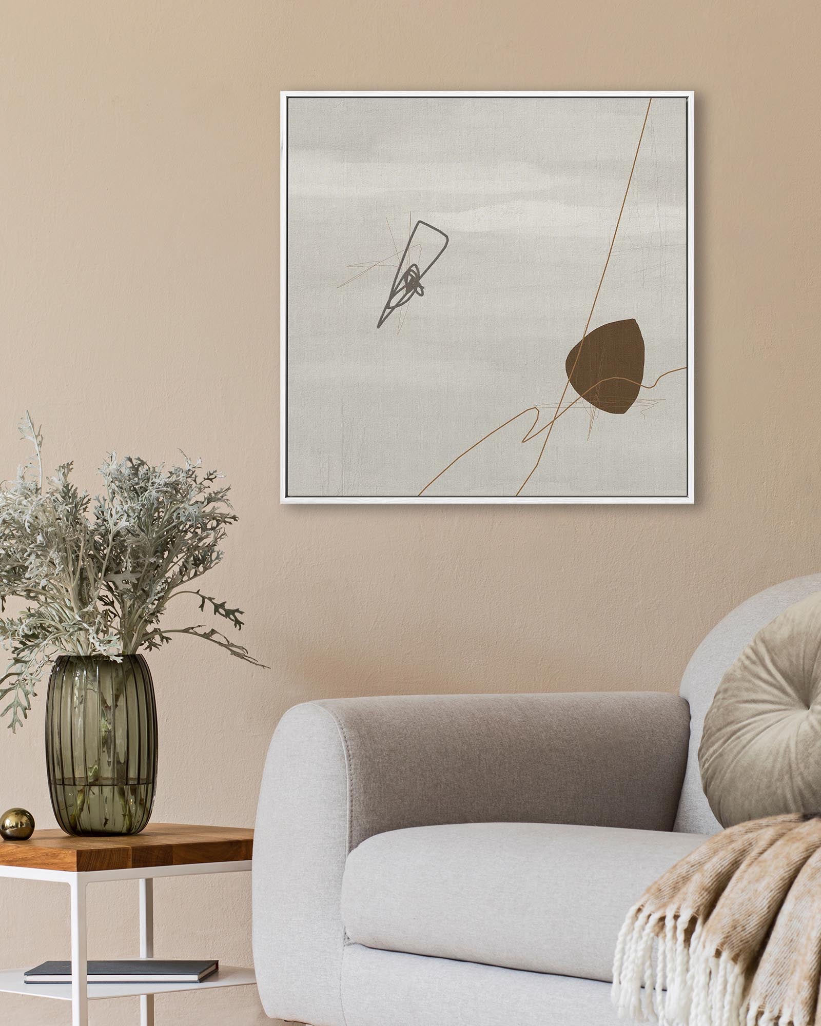 Modern living room with abstract art on the wall, a sofa, and decorative items.
