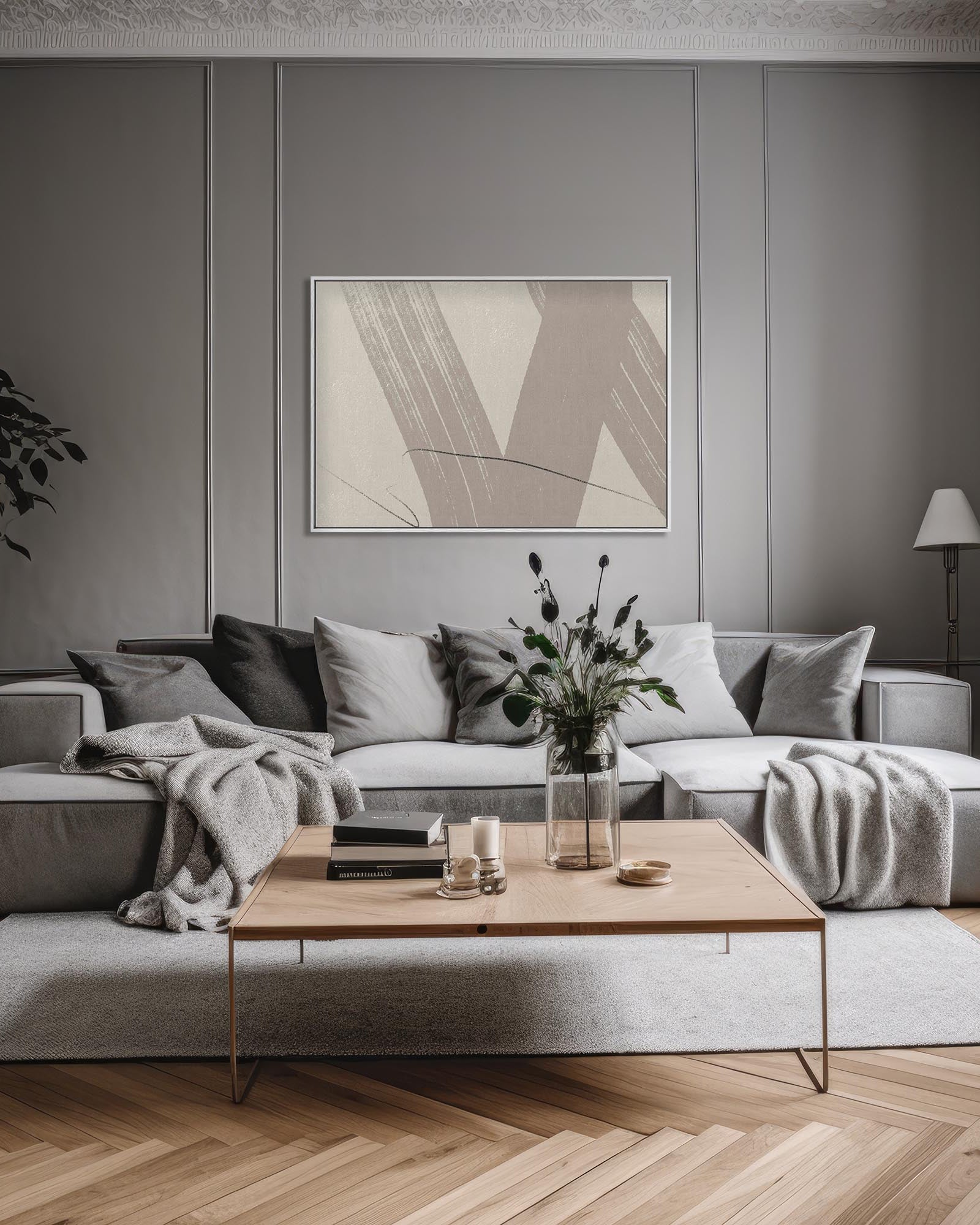 Modern living room with a gray sectional sofa, wooden coffee table, and abstract art on the wall.